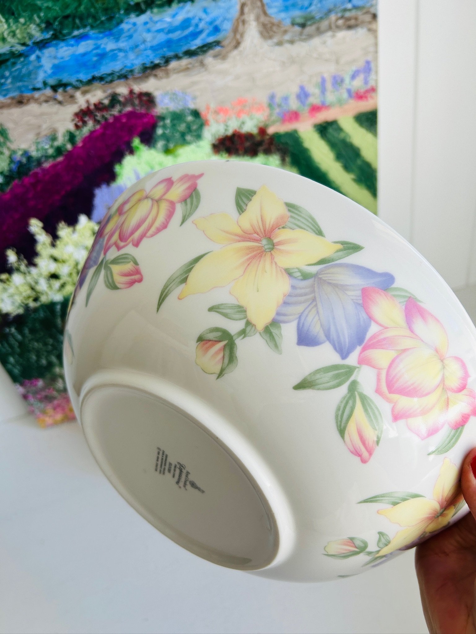 Angled view of the exterior floral design, highlighting the yellow, pink, and purple flowers and the soft blue-lilac rim