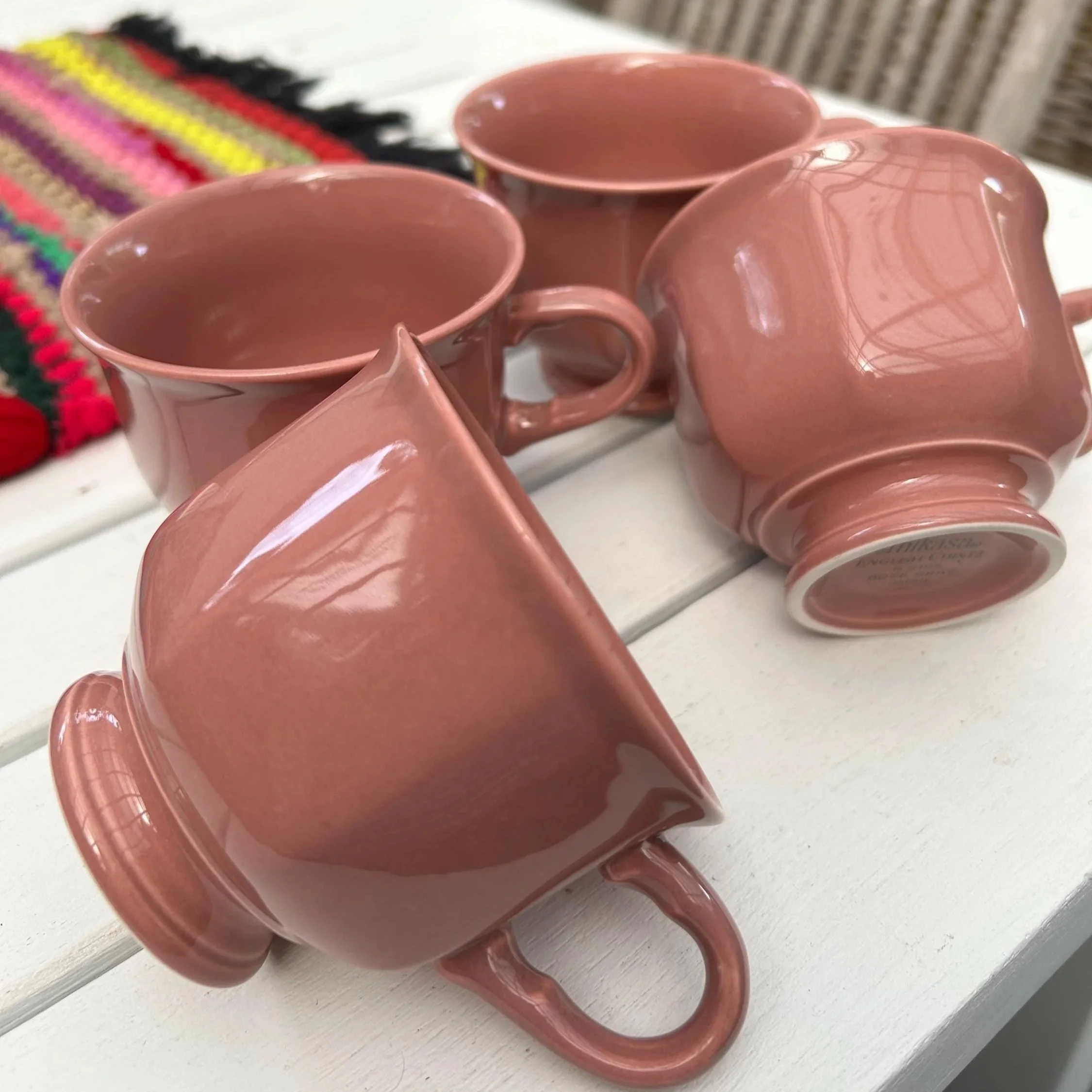 Four Mikasa Rose Gray tea cups resting together on white table