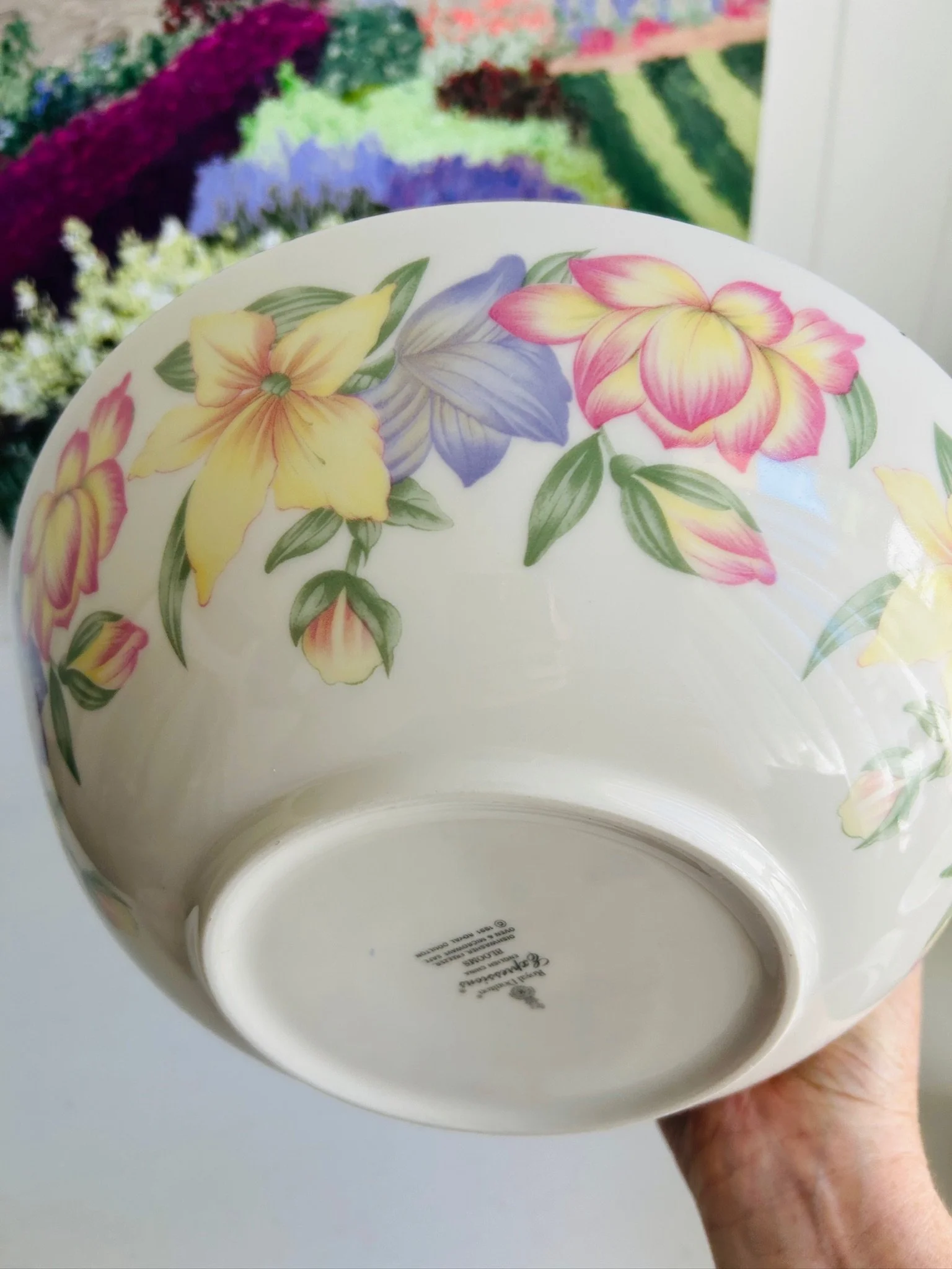 Close-up of the lower exterior of the bowl, showing the floral pattern, glossy finish, and underside shape