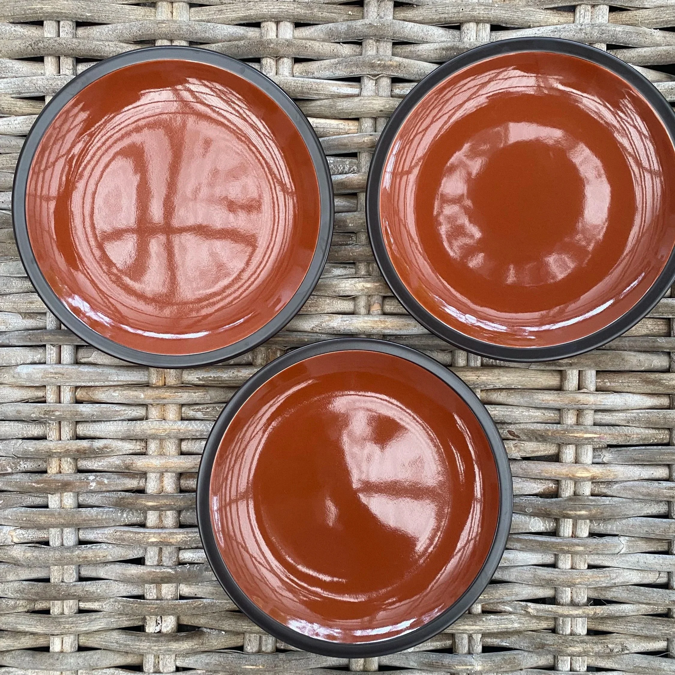 Overhead shot of three Mikasa Cinnamon salad plates on wicker background