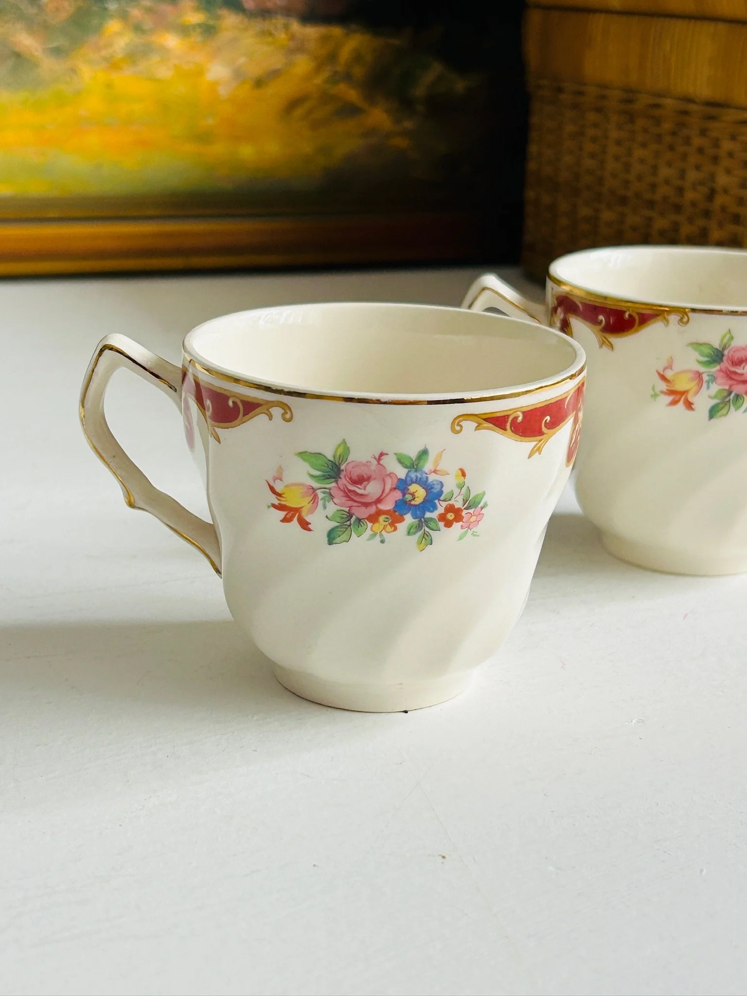 Front display view of both teacups together, showing the matching floral pattern and shaped form