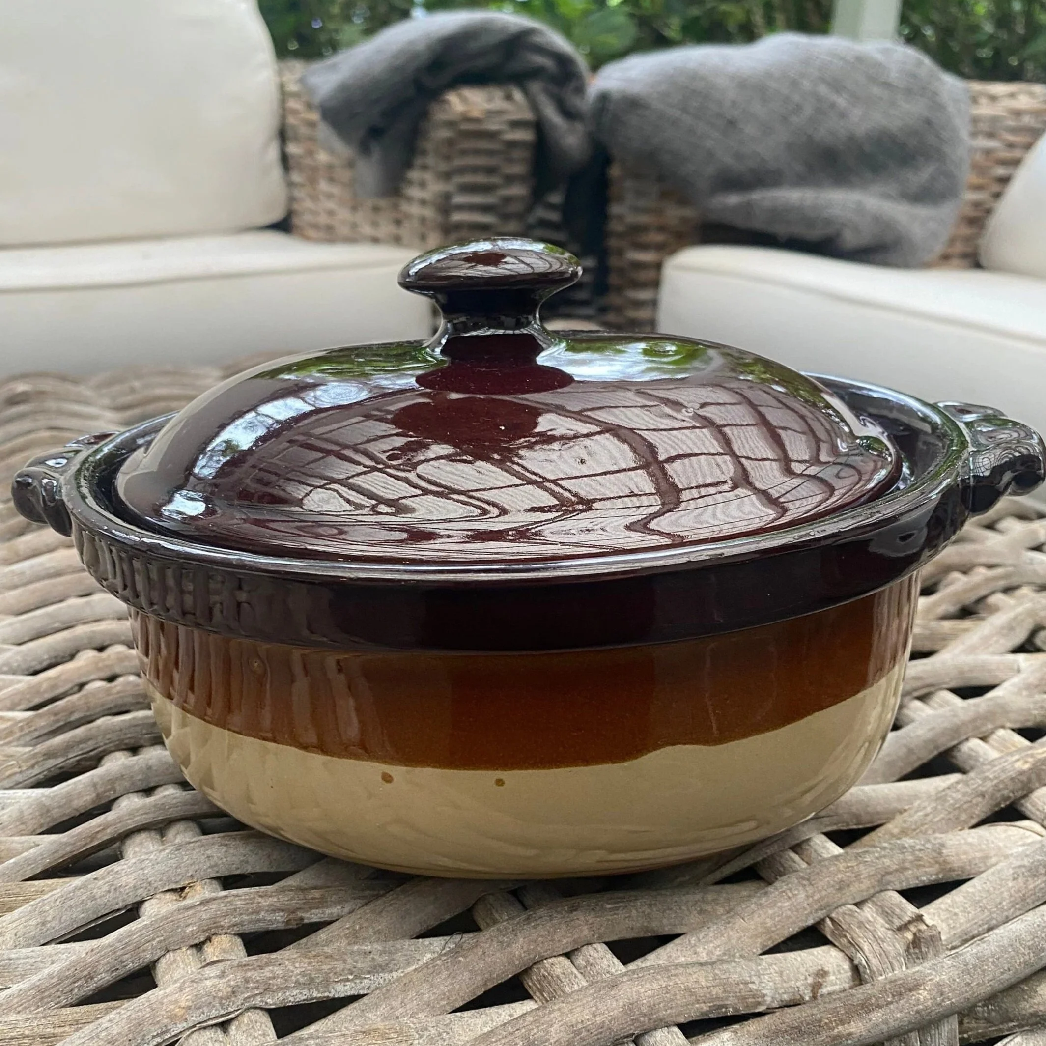 Vintage oval ceramic pot with lid in brown and cream glaze, shown from the front with side handles visible
