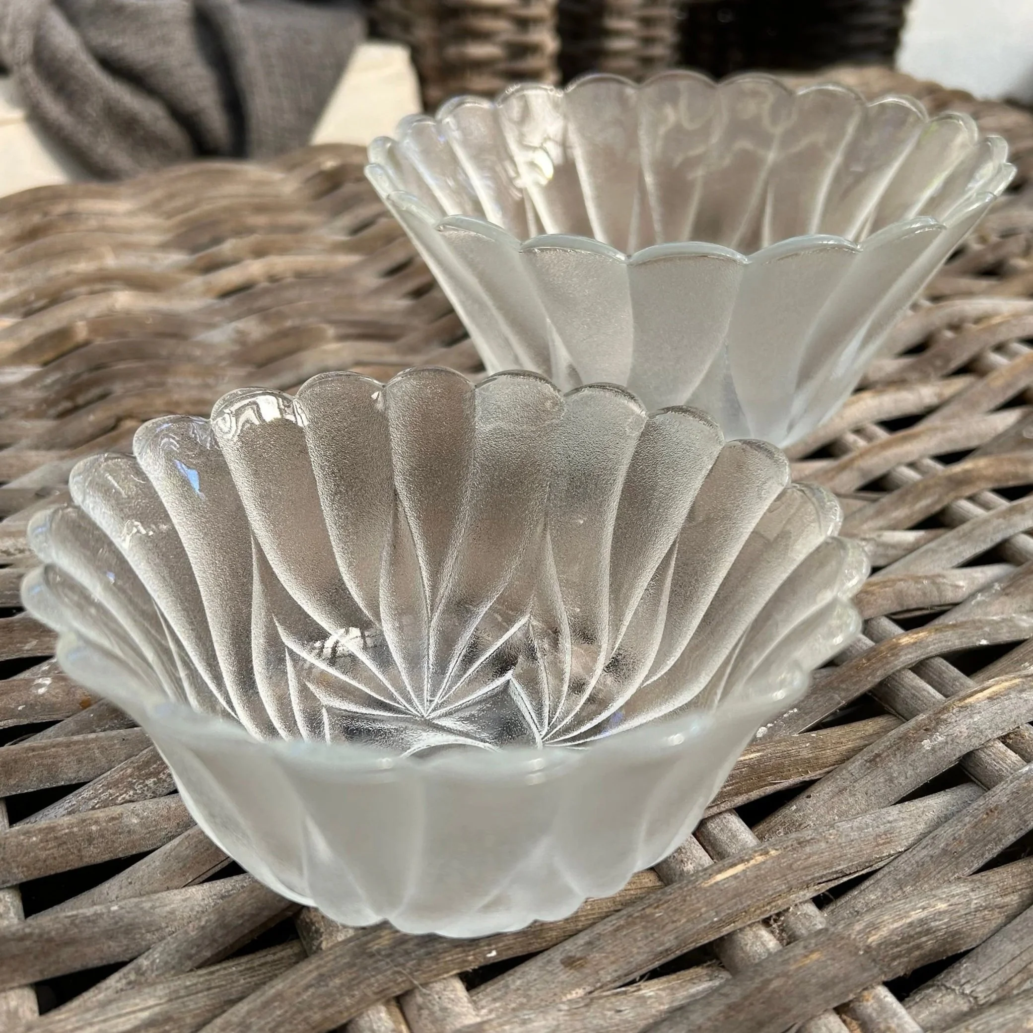 Two frosted pressed glass bowls with swirl pattern stacked together