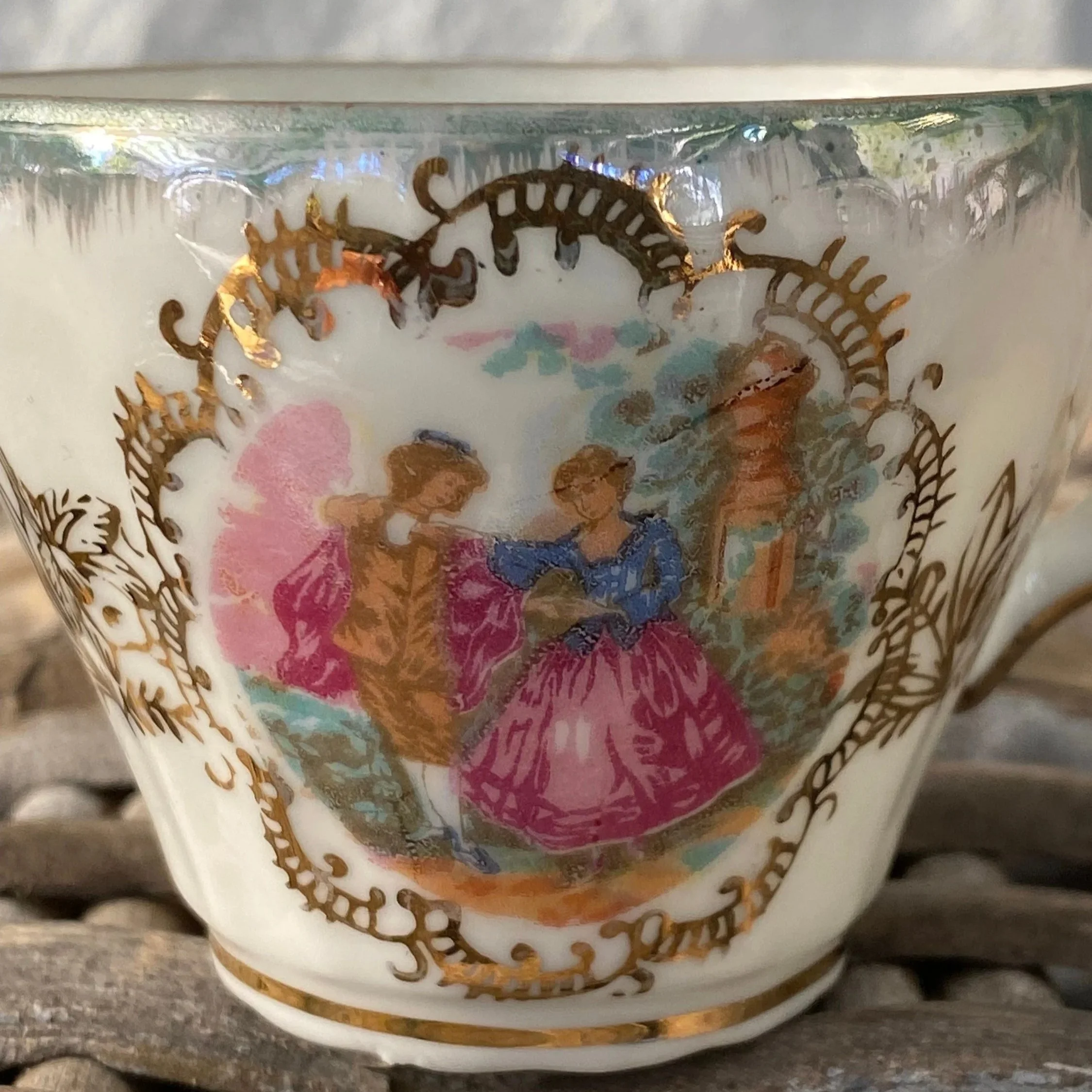 Close-up of Limoges-style courting couple design on cup front