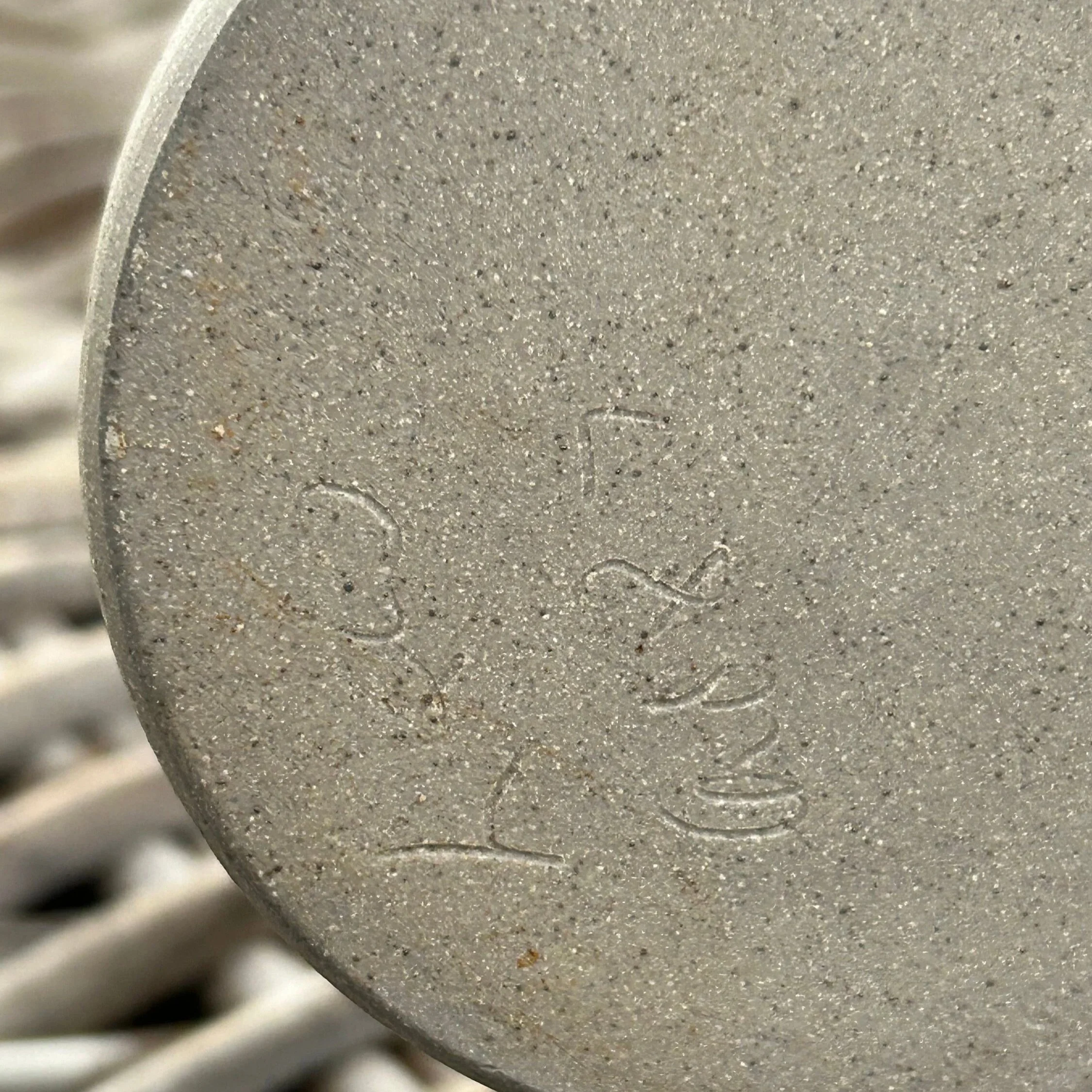 Artist's signature and date "1987" carved into base of pot