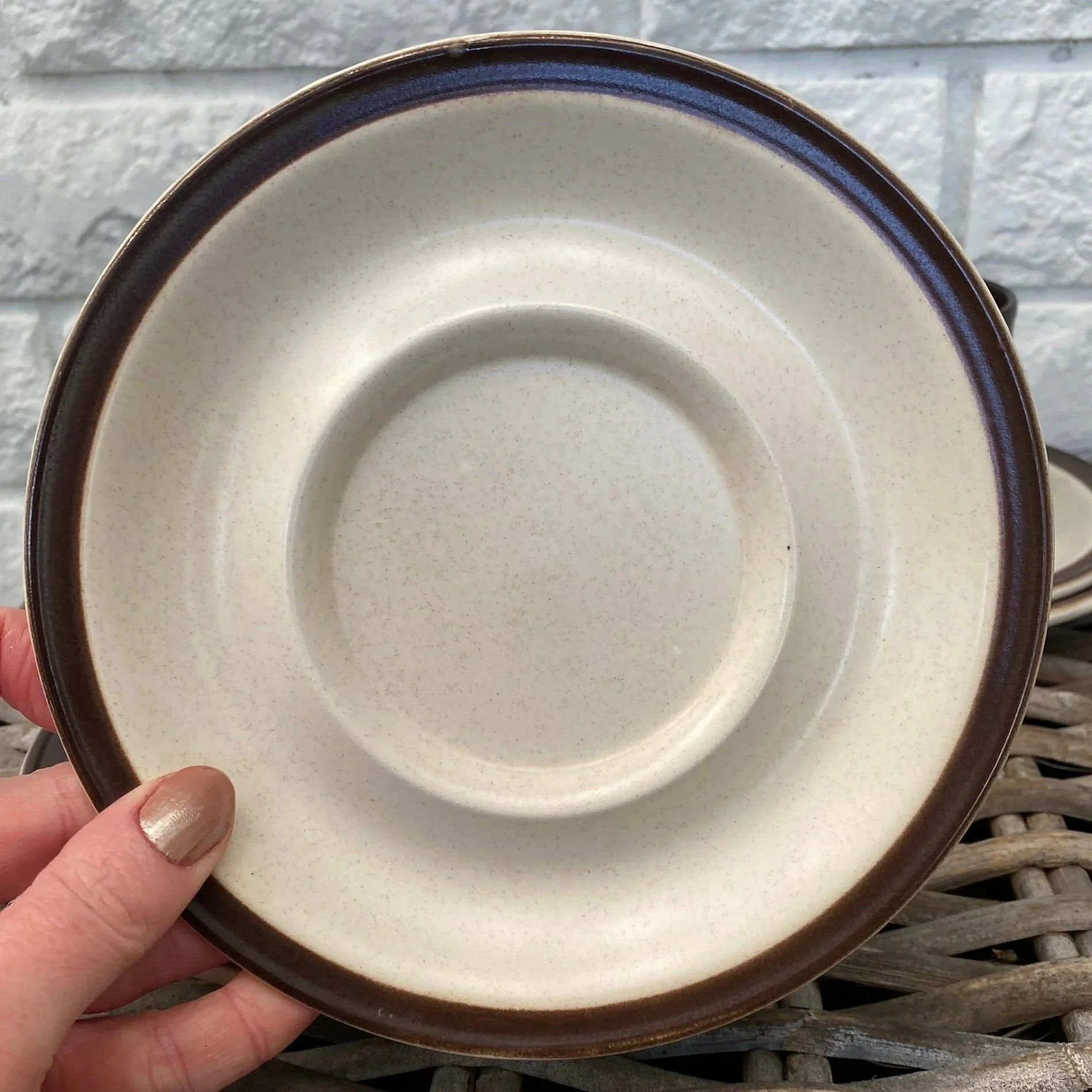 Saucer detail showing raised cup ring and speckled glaze