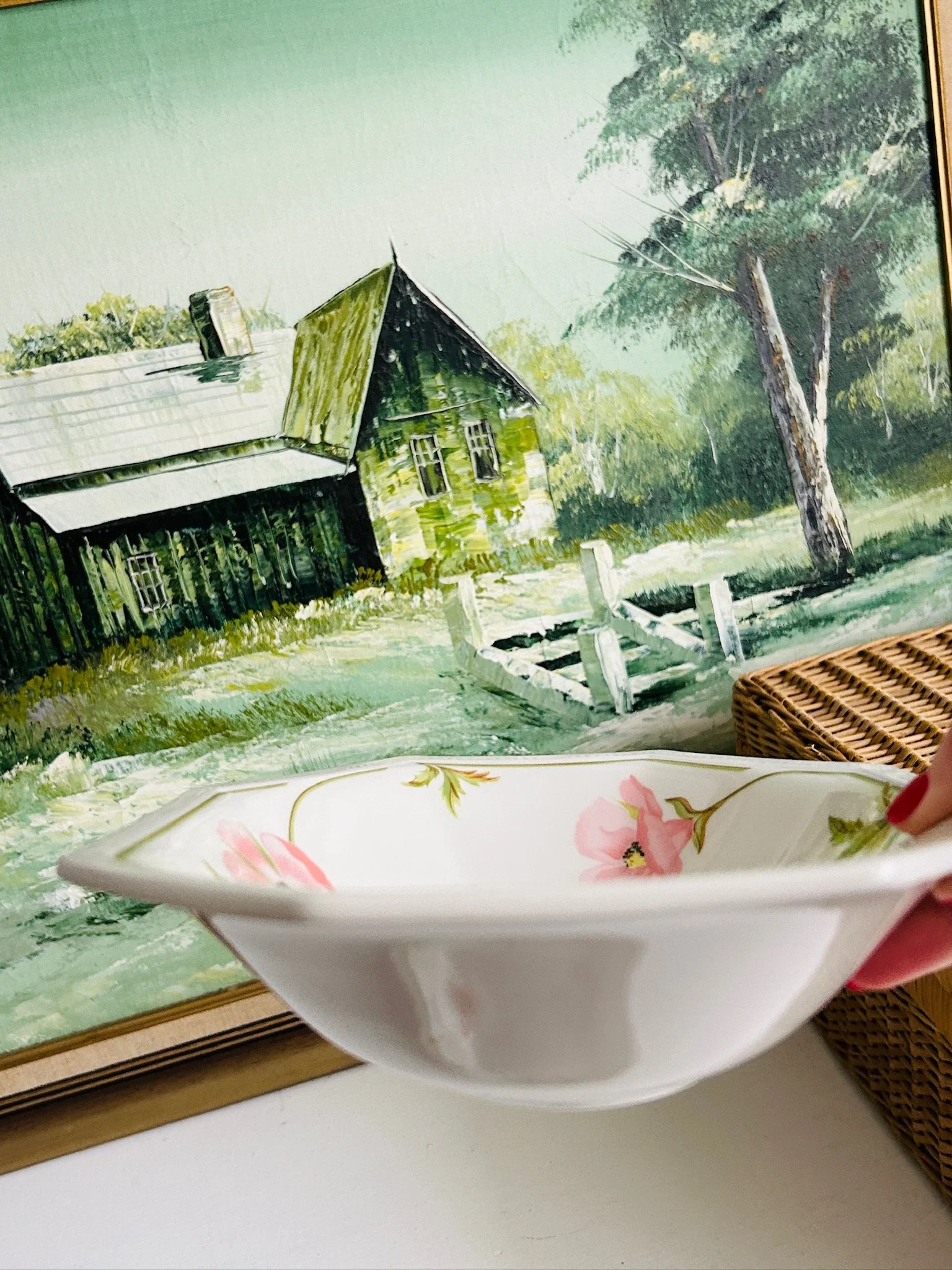 Side profile of one bowl held in hand, showing the depth, curved sides, and octagonal rim shape.