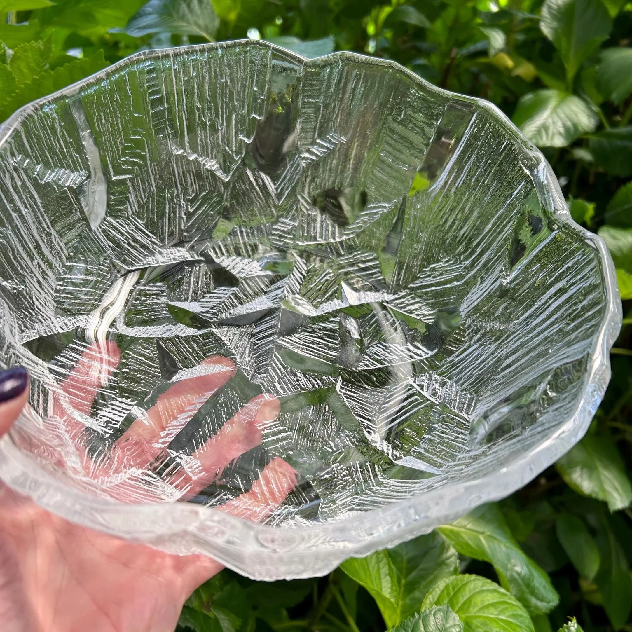 Large vintage Mikasa Hoya bowl held against green foliage – showing textured ice glass design