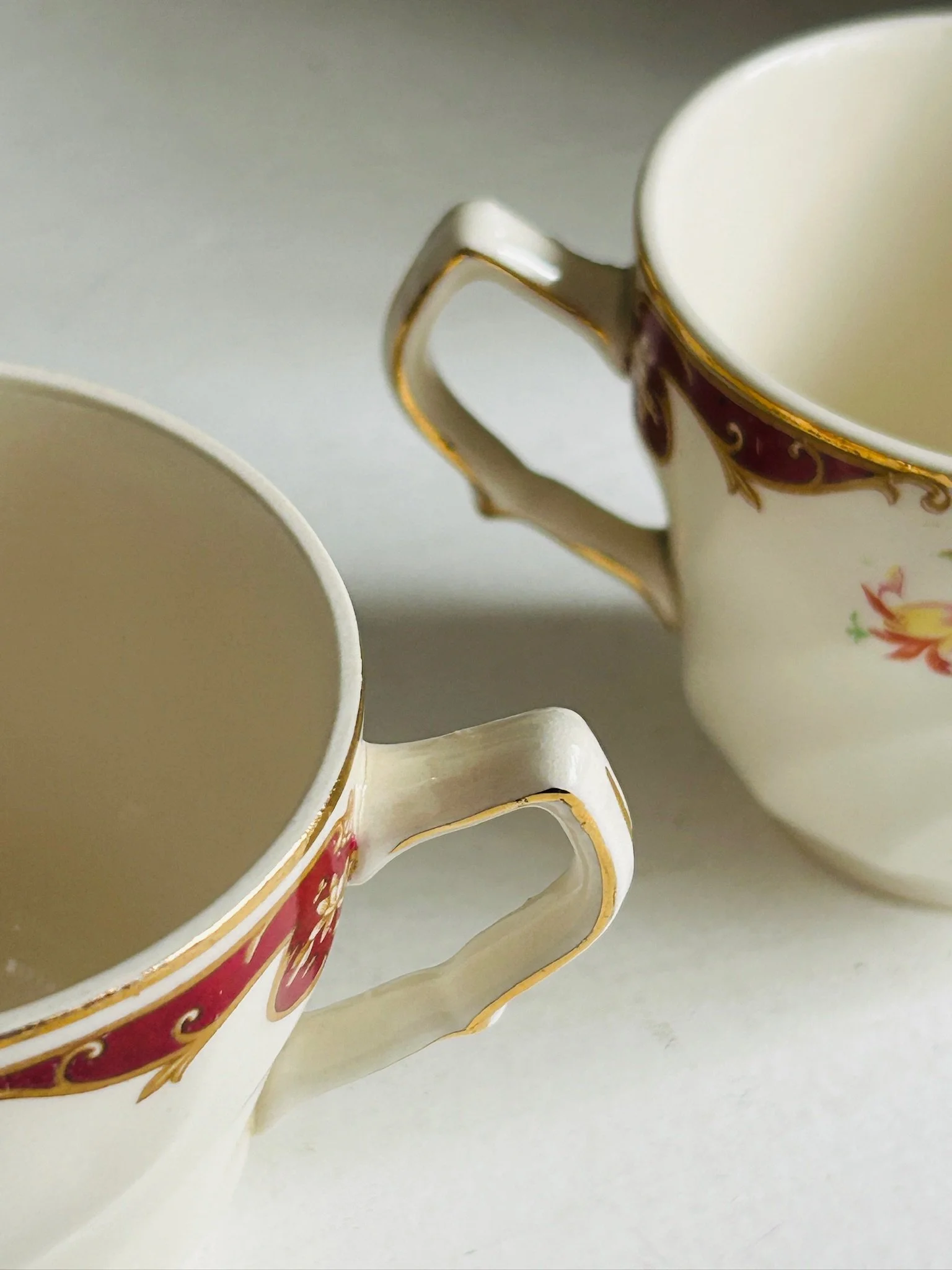 Angled view of the teacup handle and rim showing gold trim and interior shape
