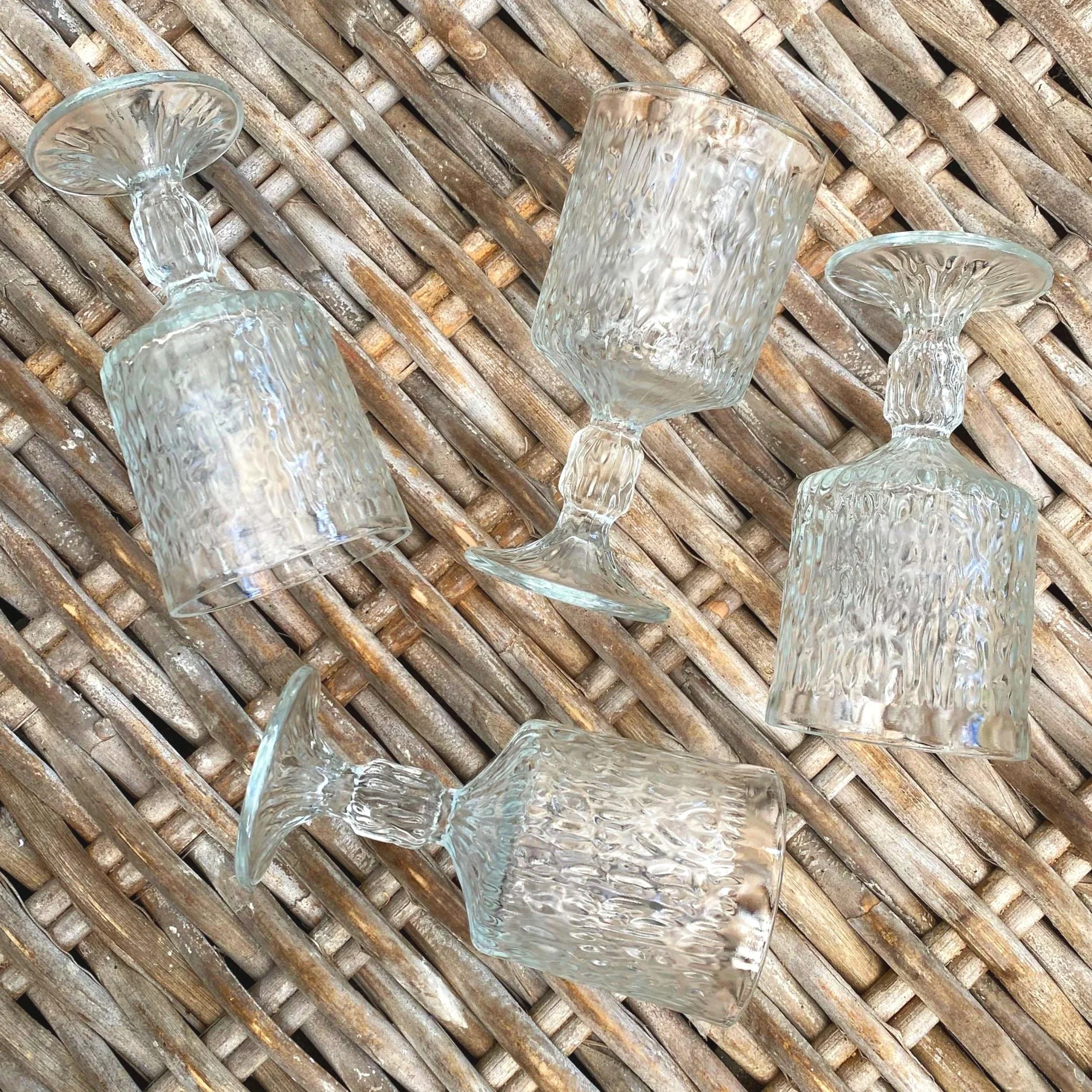 Top-down flat lay of all five glasses showing bases and bowl texture