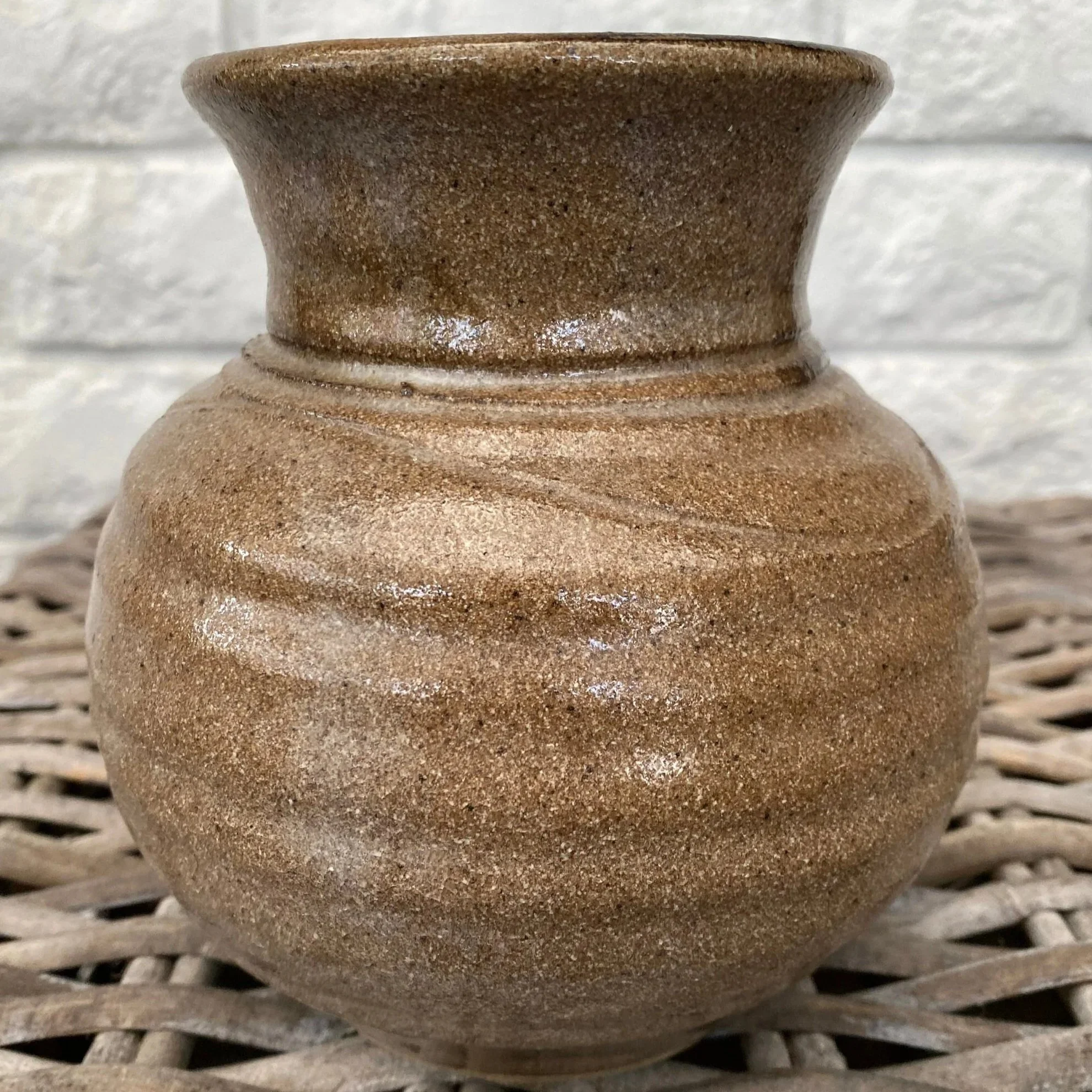 Rear of vase showing smooth ribbed ceramic without decoration
