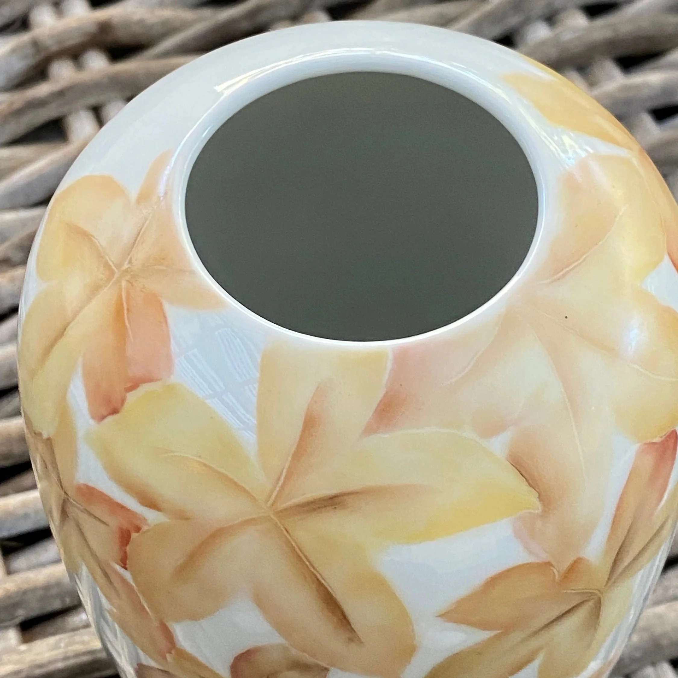 Top-down view showing vase opening and autumn leaf design detail