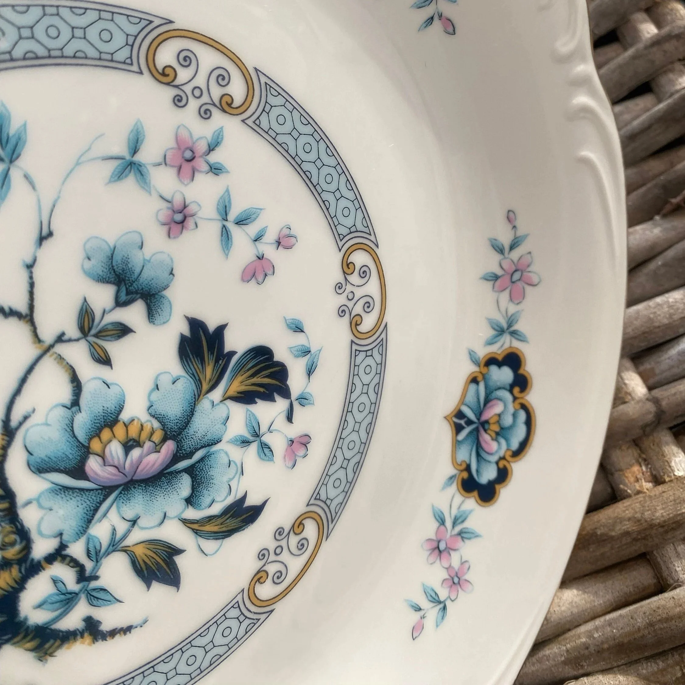 Close-up of the inner border and rim showing floral detailing and embossed pattern around the edge