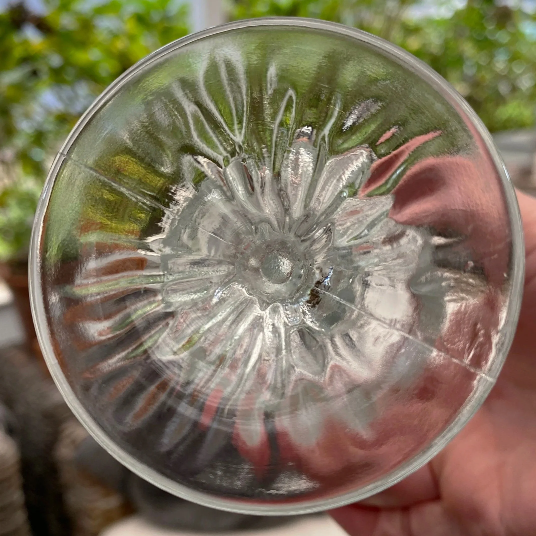 Bottom of glass revealing sunburst pressed base design