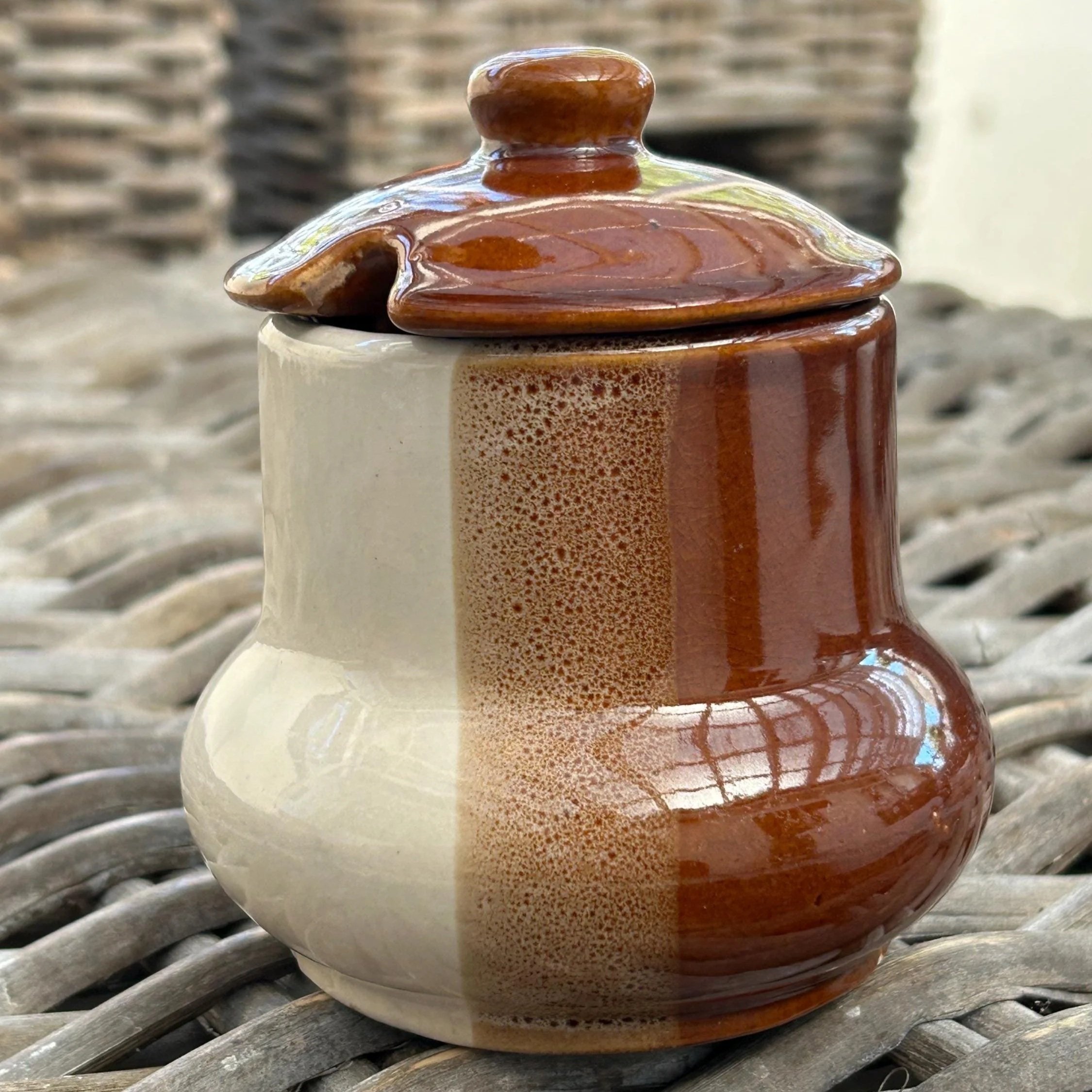 Front angle of tri-toned sugar bowl with lid on, showing full glaze