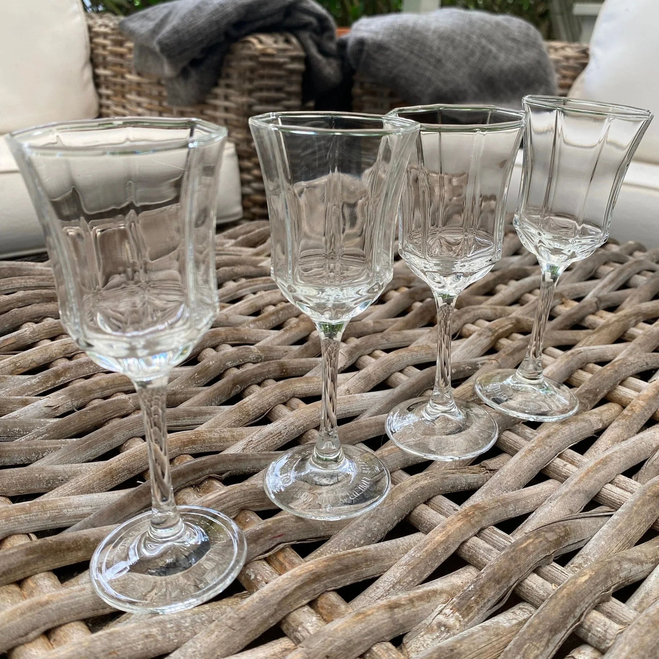 Set of four Moët & Chandon Luminarc Octime glasses on wicker table