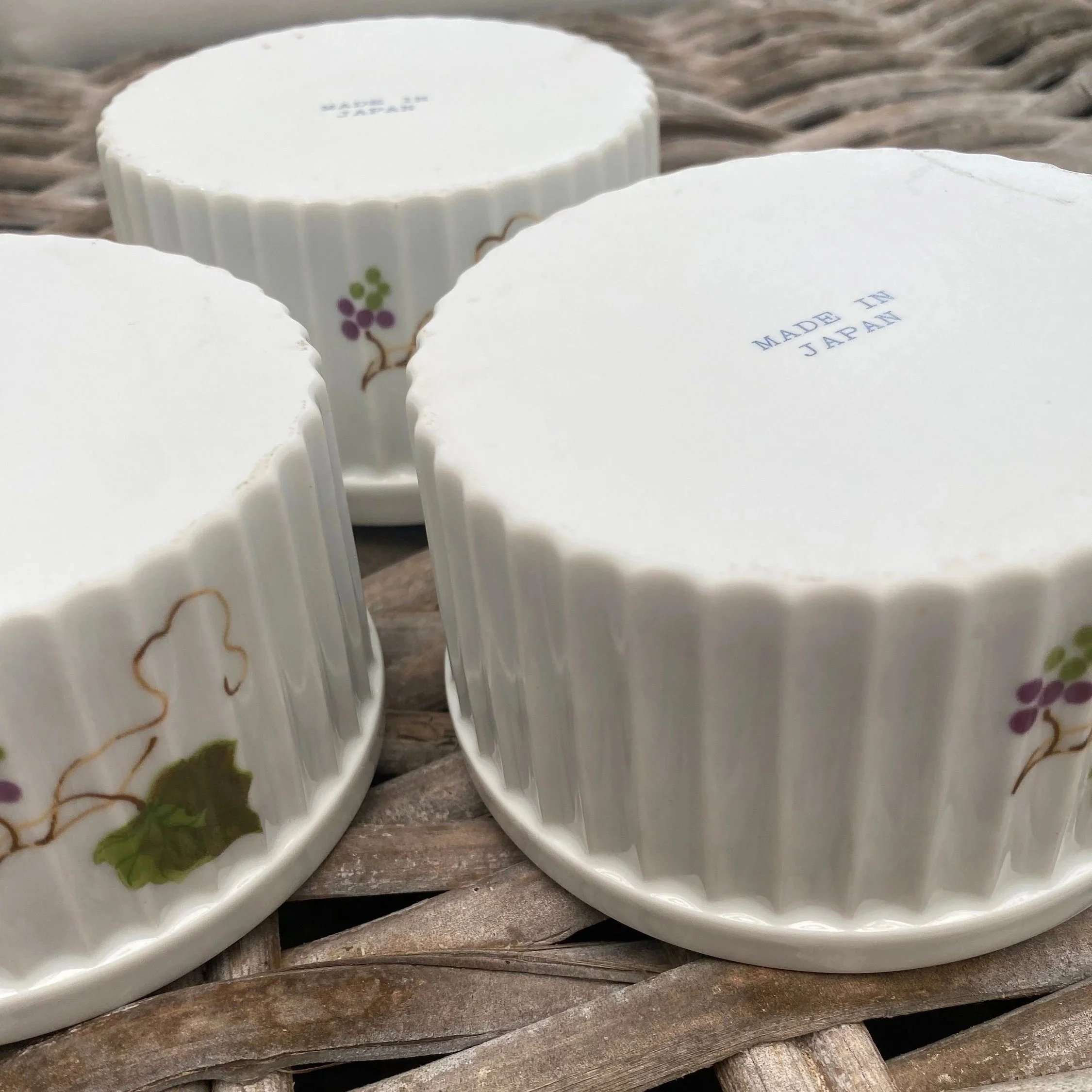 Side profile of vintage stoneware ramekins highlighting fluted texture