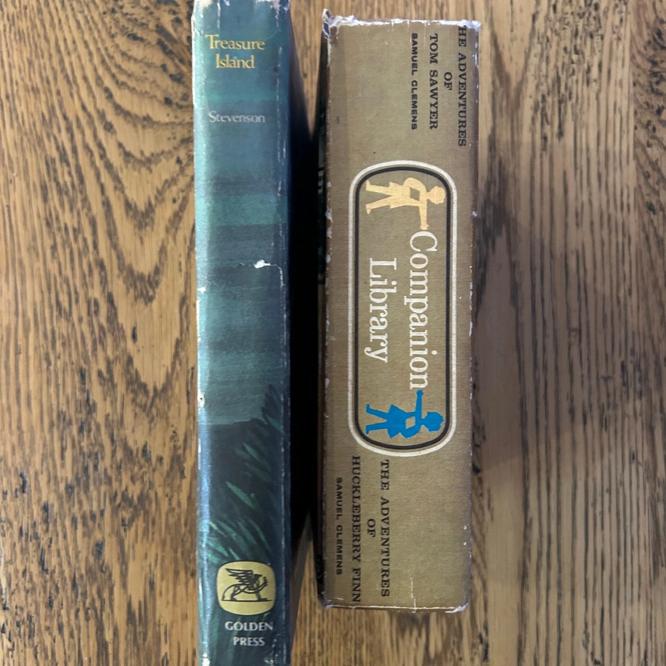 Spines of vintage Companion Library hardcover books showing publisher marks and wear