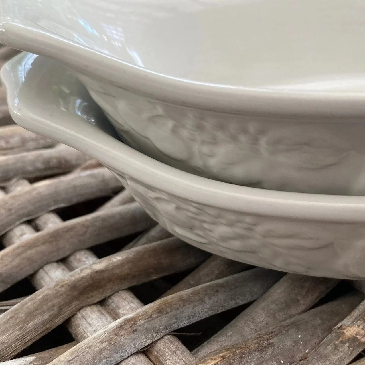 Side view of stacked oval and gratin dishes highlighting depth