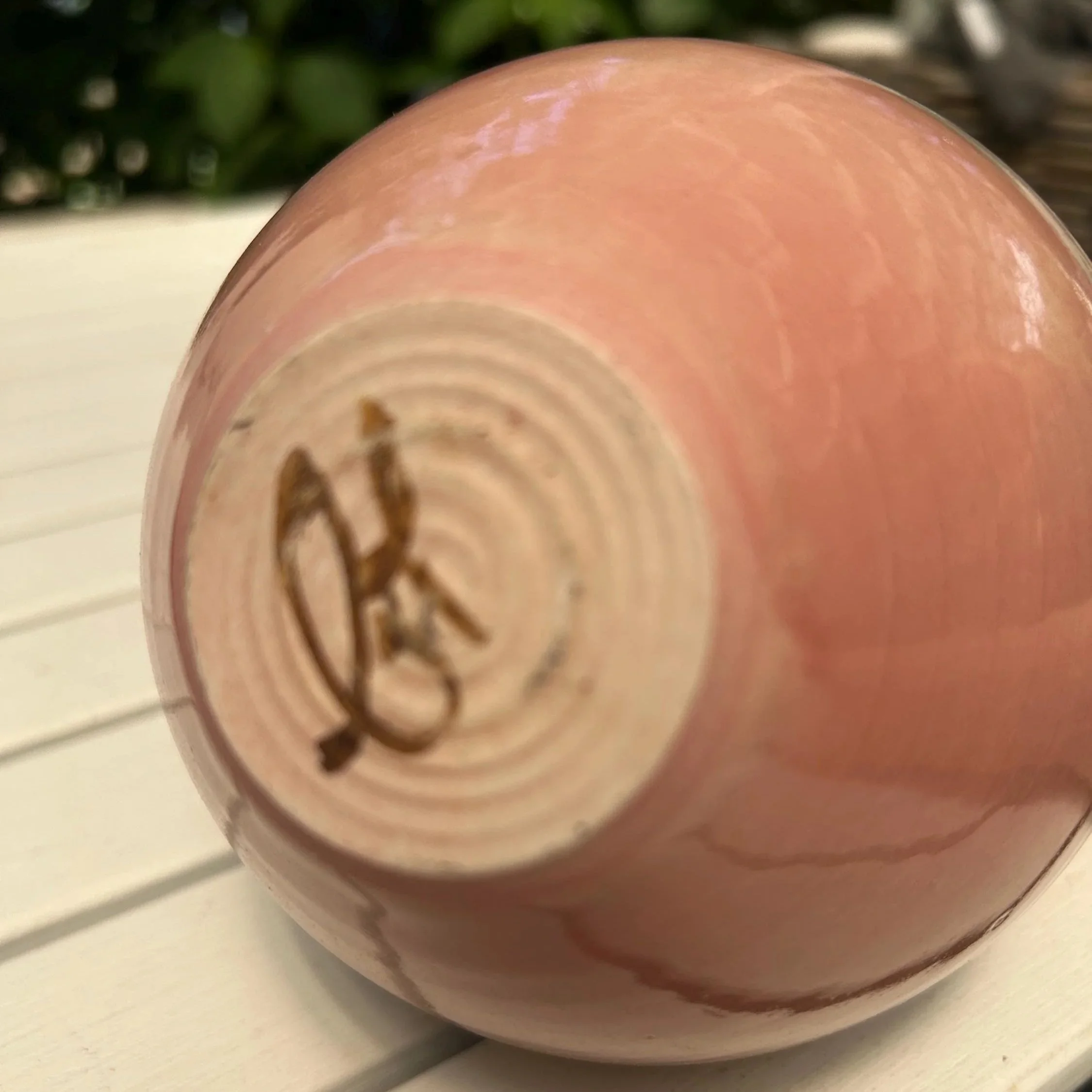 Unglazed base showing artist’s signature carved into clay