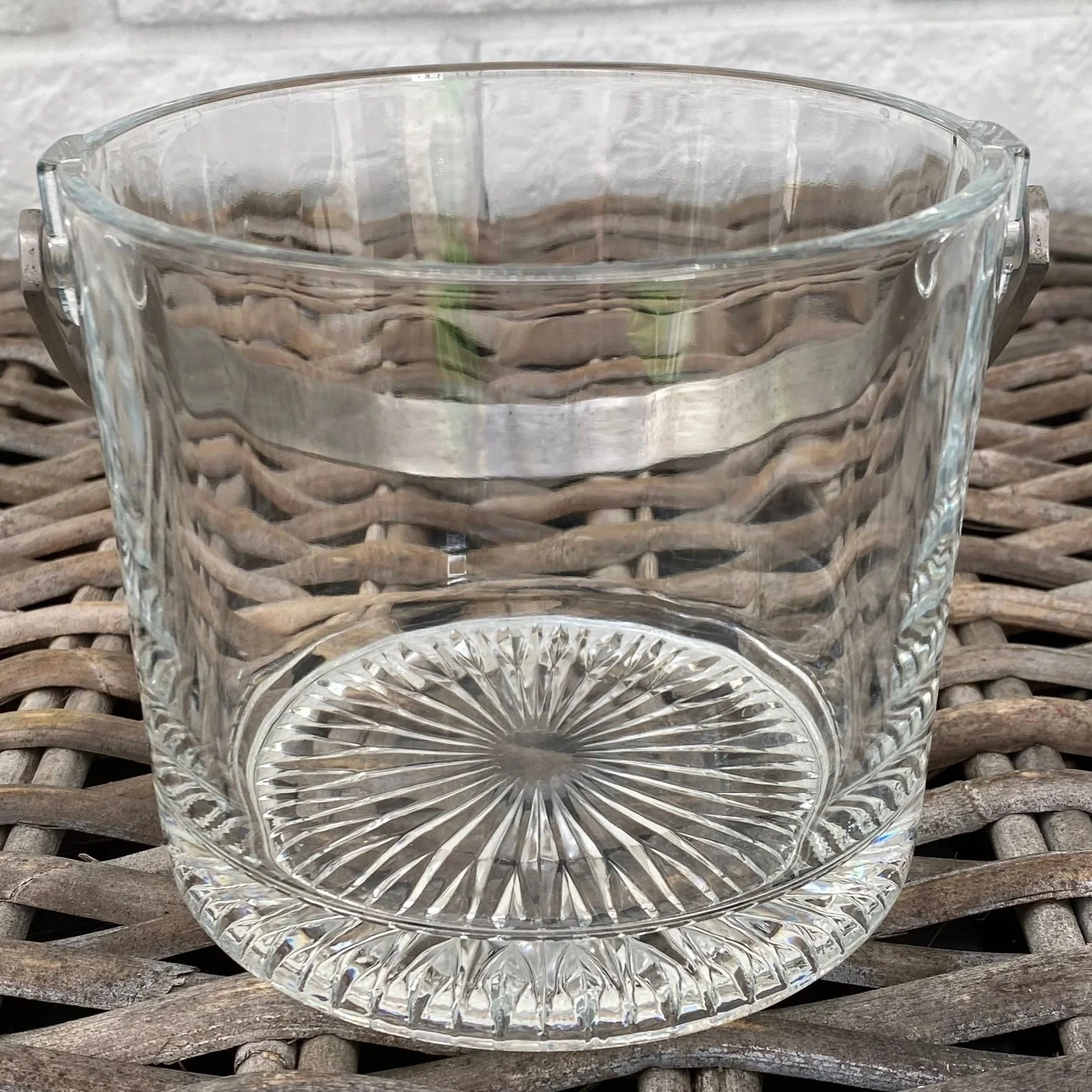 Front view of vintage glass ice bucket with ribbed sides and starburst base