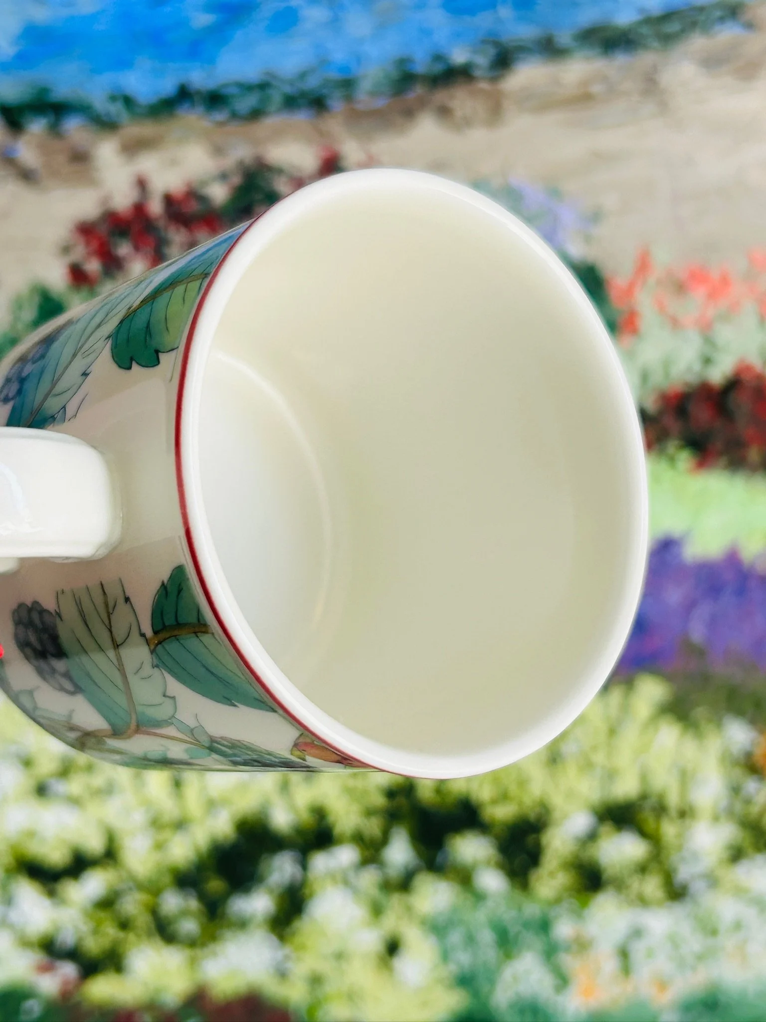 Top view into the coffee cup showing the plain white interior and red band at the rim.
