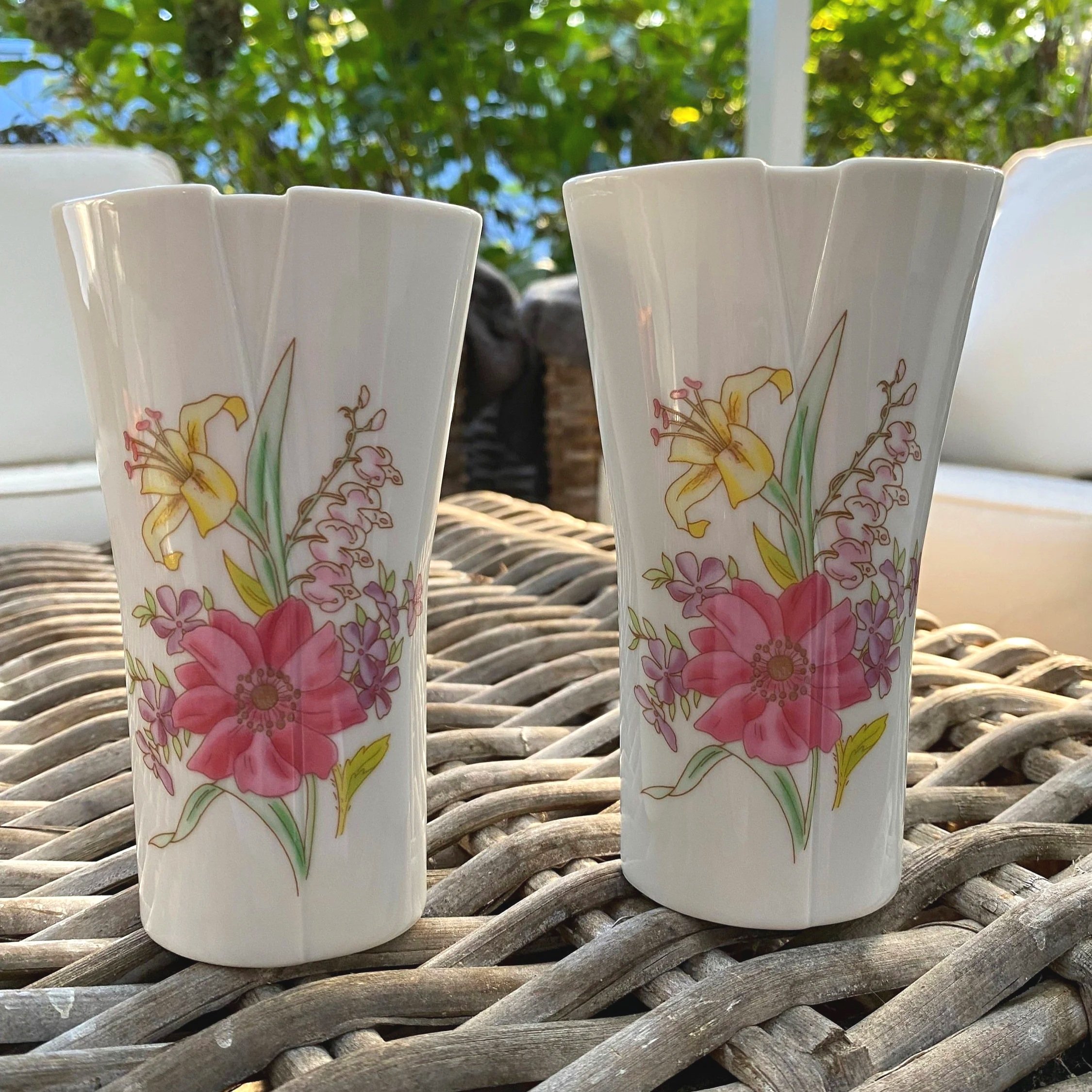 Pair of porcelain vases standing upright showing full floral designs
