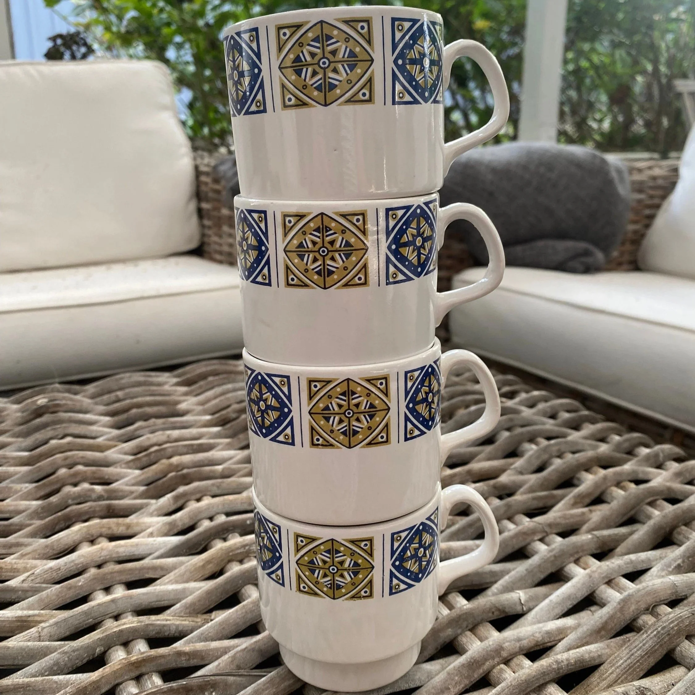 Four mugs stacked vertically to demonstrate nesting capability