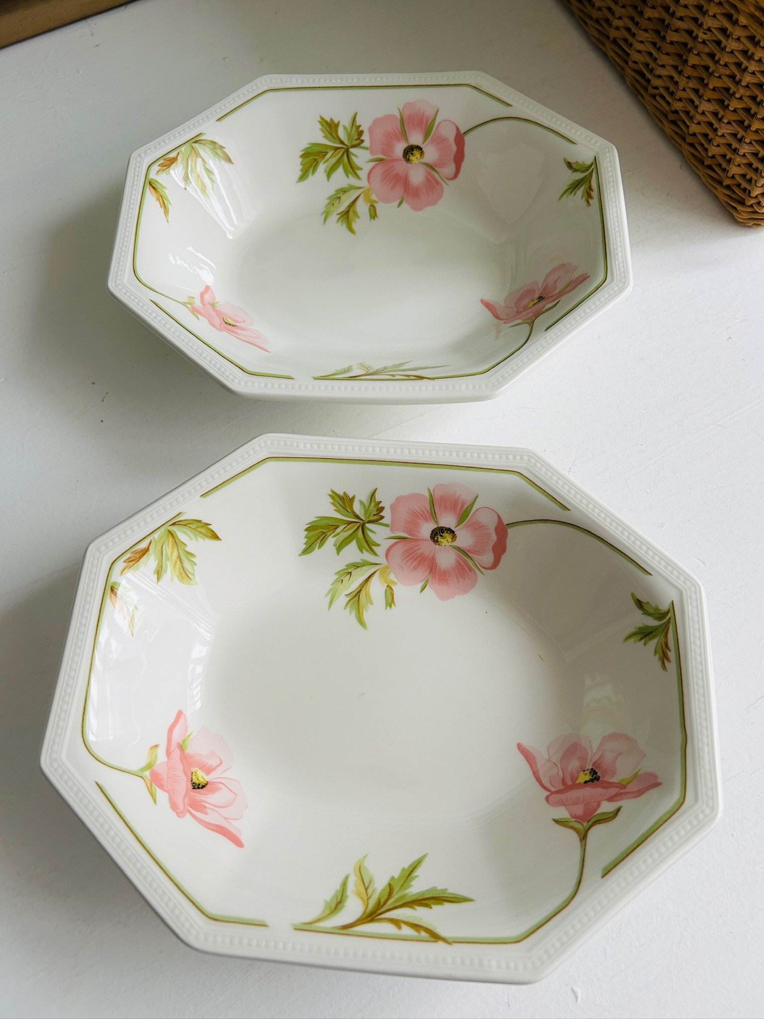 Overhead view of both floral serving bowls, showing the full octagonal shape and placement of the pink blossom motifs.