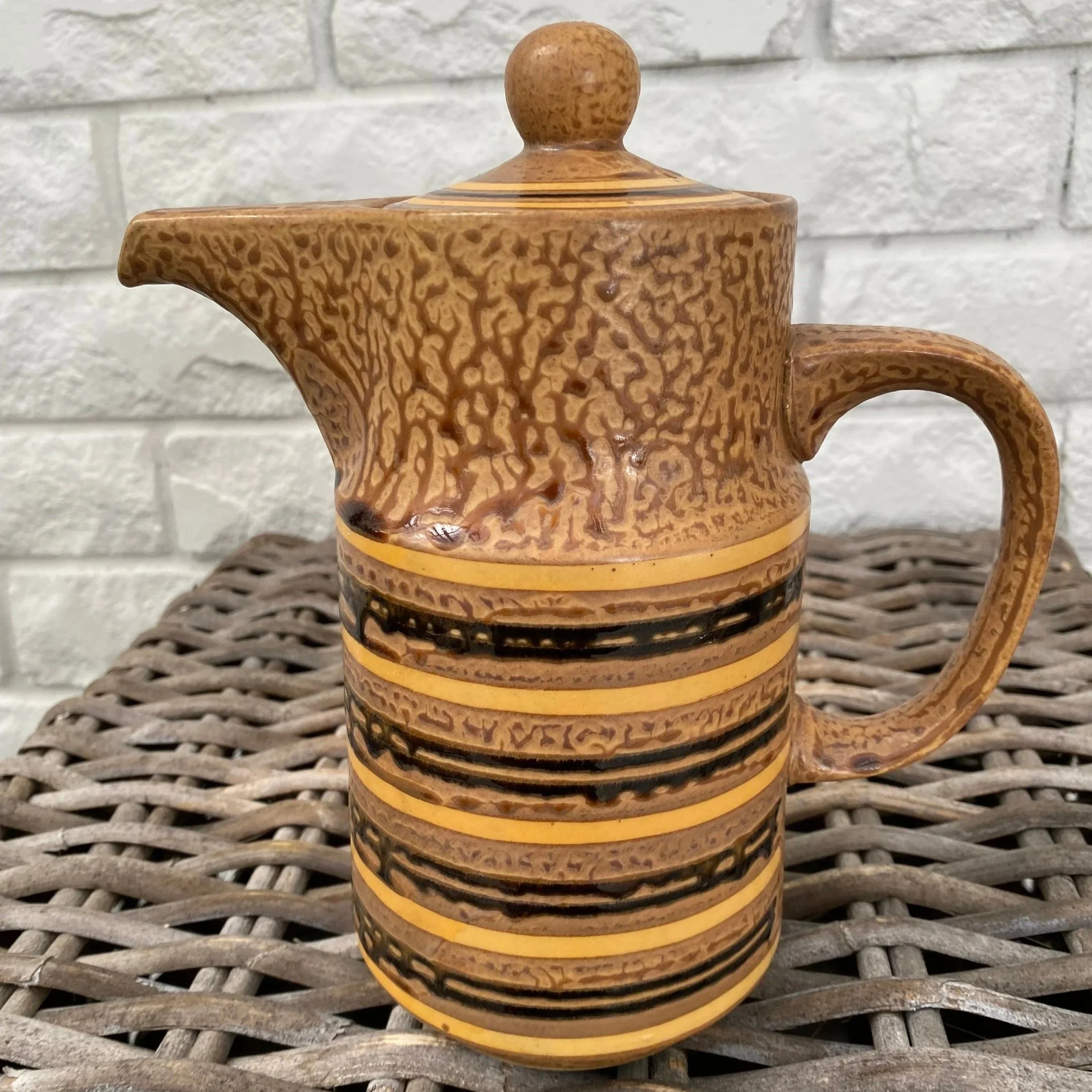 Tall coffee jug with distinctive mottled glaze and round lid knob