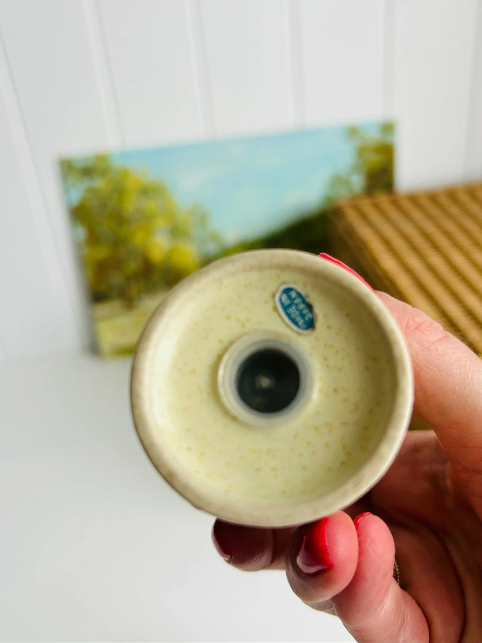 Close-up of the underside of one shaker held in hand, showing the base opening and original “Made in Japan” sticker