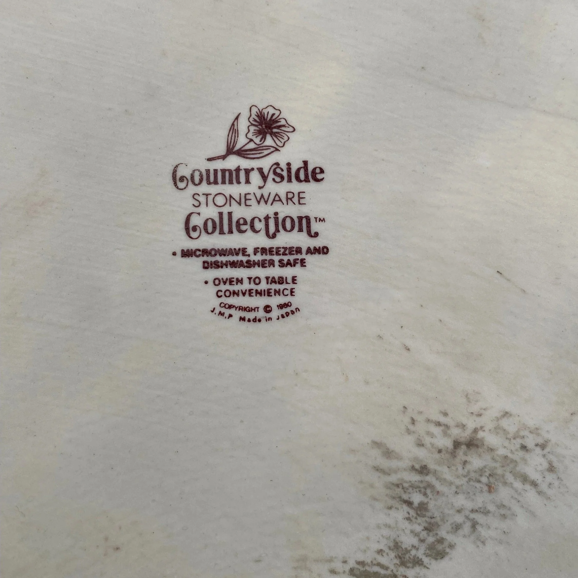 Close-up of backstamp: “Countryside Stoneware Collection – JMP Marketing”