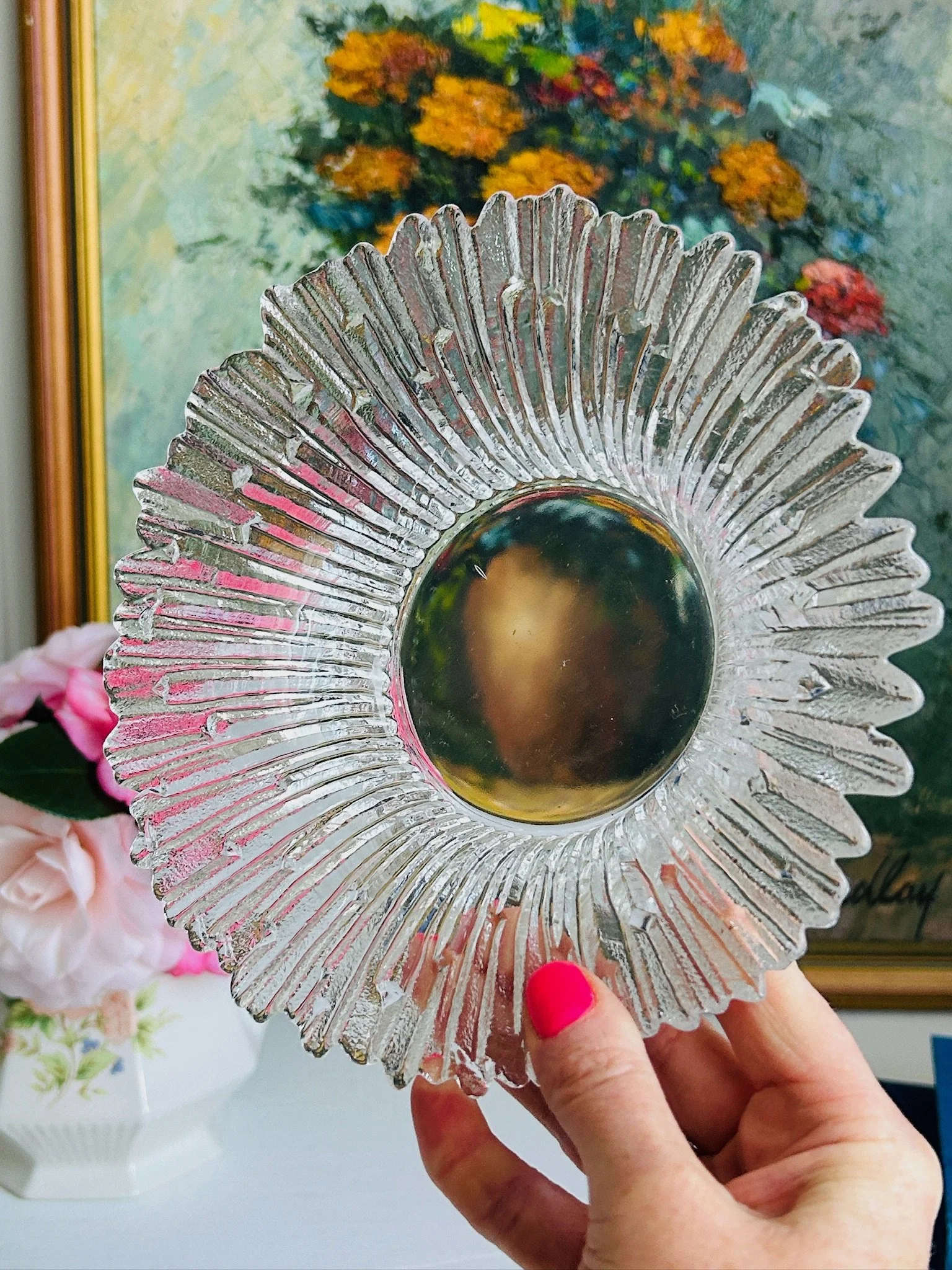 Finnish mould-cast glass dish held to the light, polished central well reflecting warm gold tones