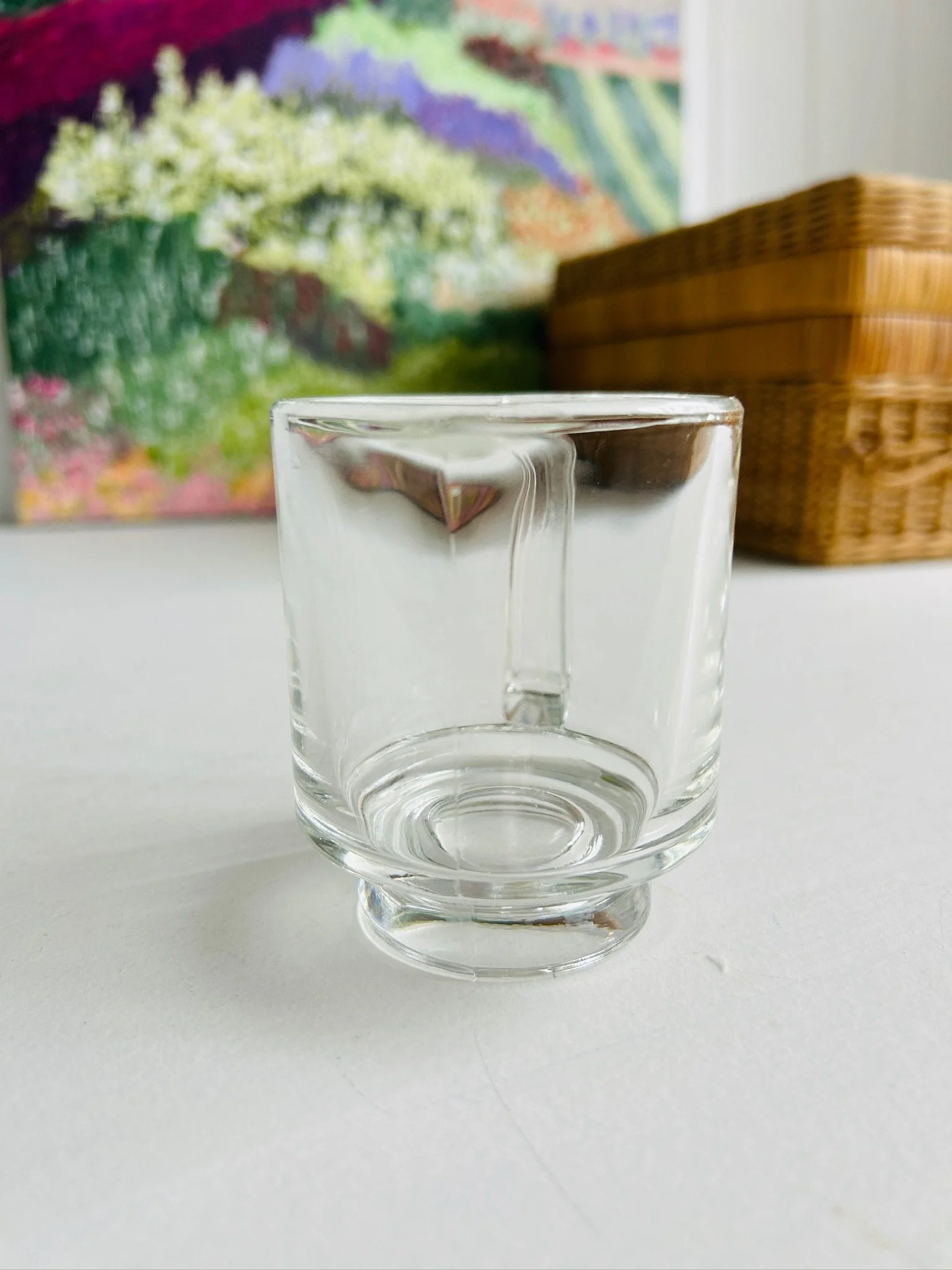 Front view of the vintage Italian pressed glass creamer highlighting its transparent body, thick base, and minimalist modernist design