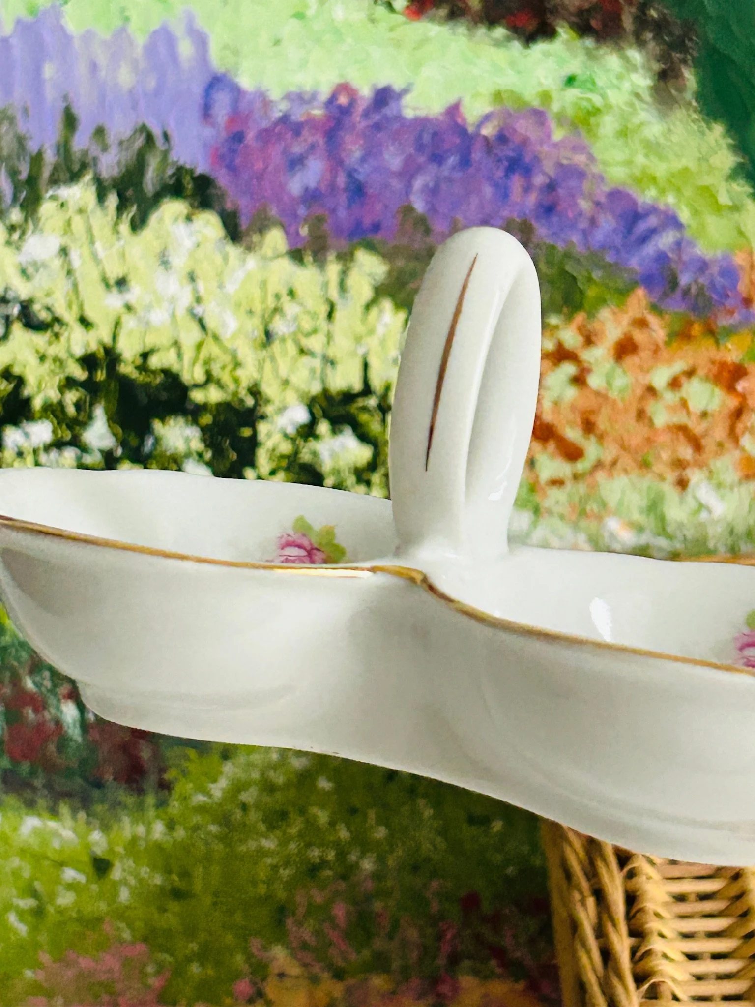 Side profile of the double salt cellar showing bowl depth, gold edging, and loop handle