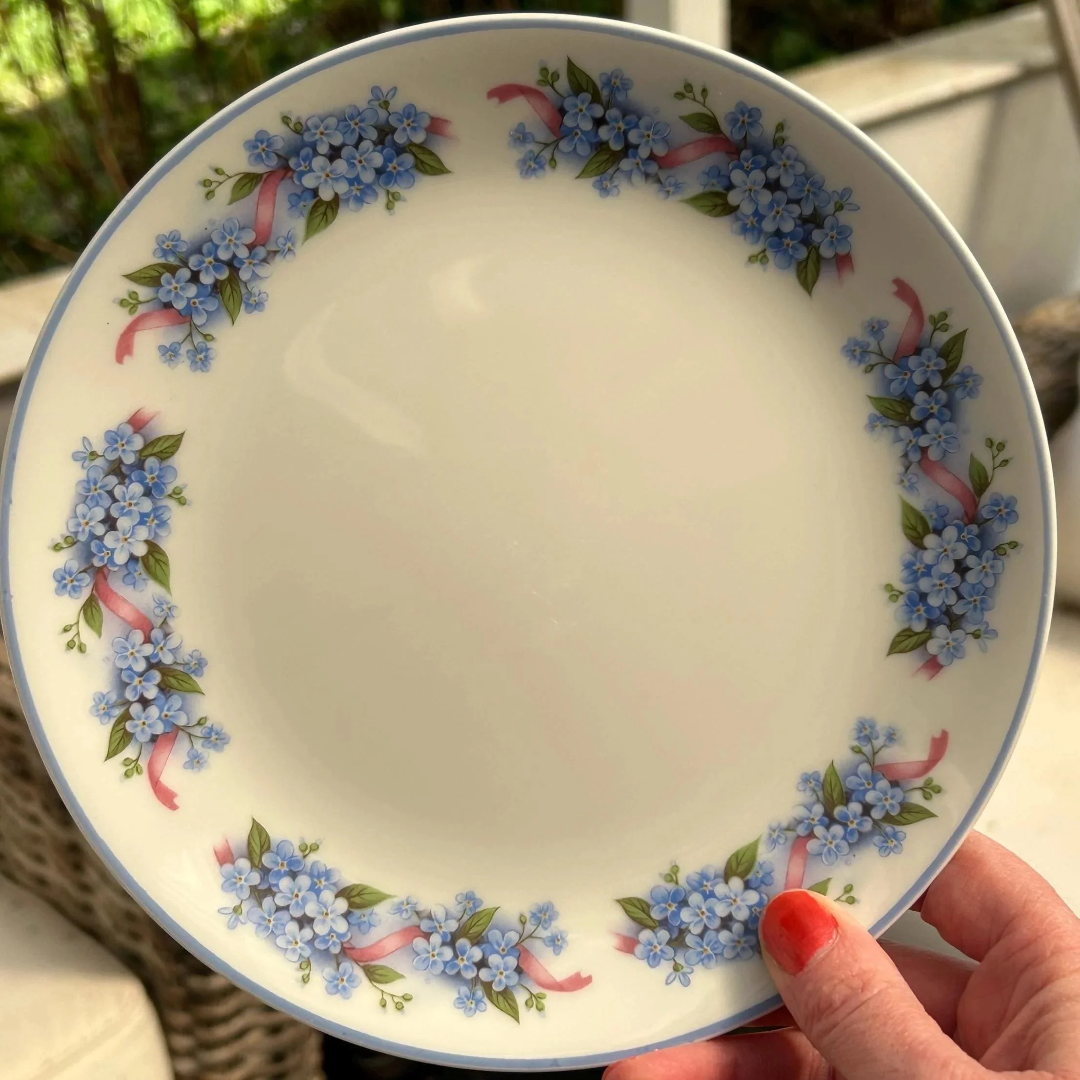 Plate held in hand to show scale and glaze finish