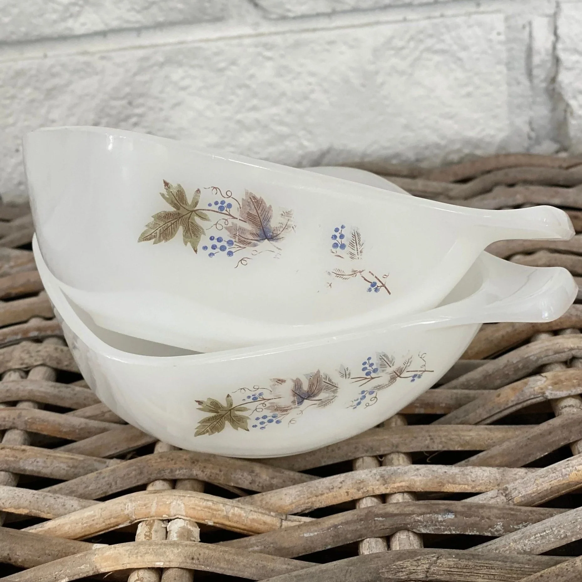 Stack of two Crown Pyrex ramekins with ‘Bacchus’ pattern visible on side