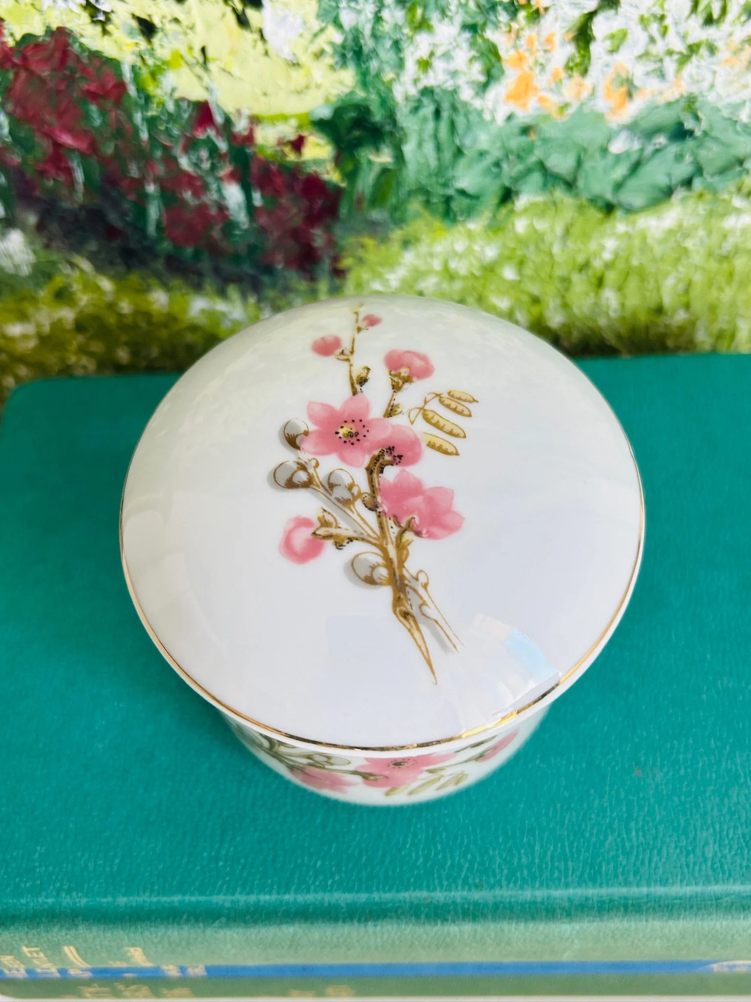 Overhead view of the lidded trinket bowl, showing the full floral design centred on the lid and the rounded porcelain shape