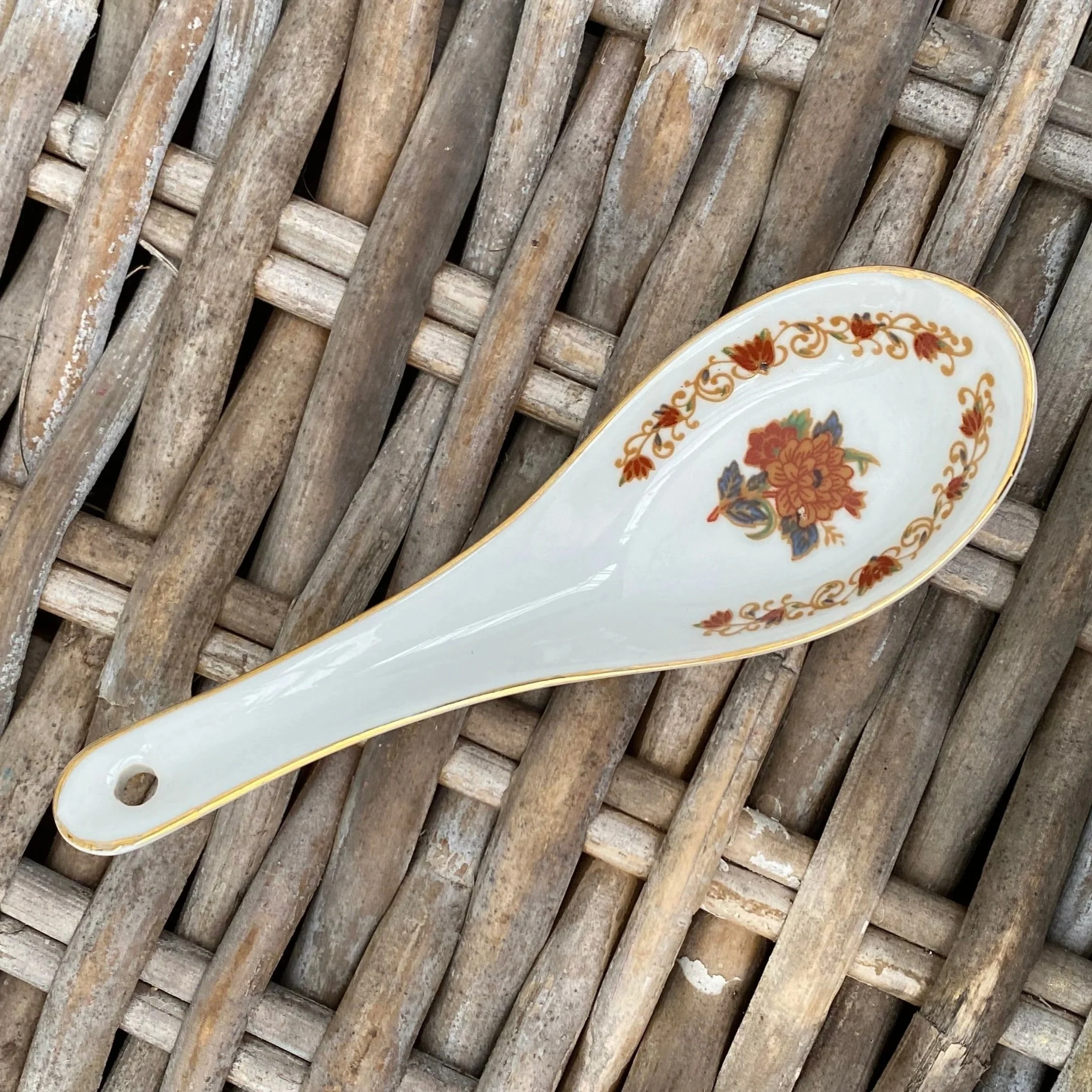 Close-up of porcelain spoon with matching floral print