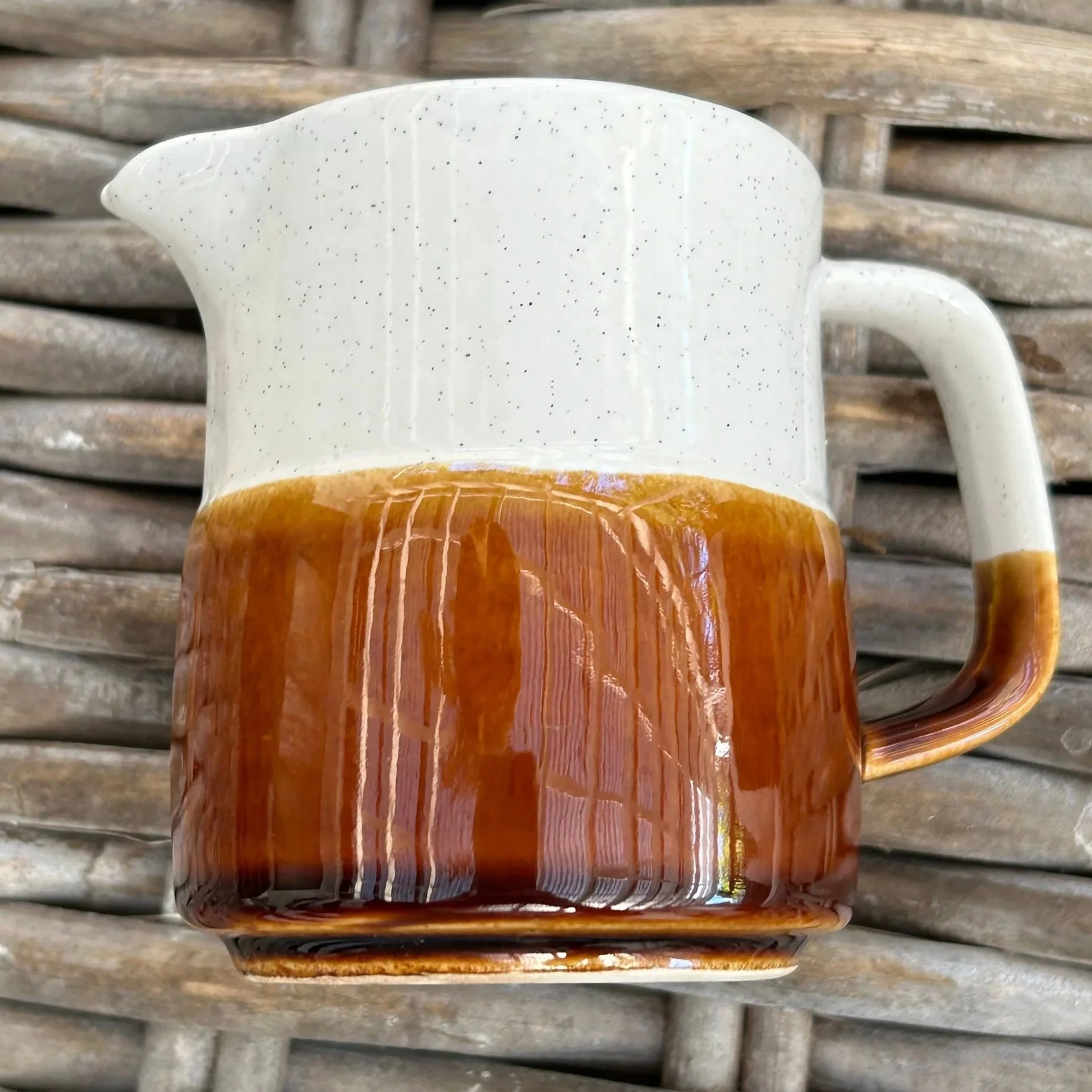 Rear view of the vintage creamer highlighting the squared handle and tritone glaze