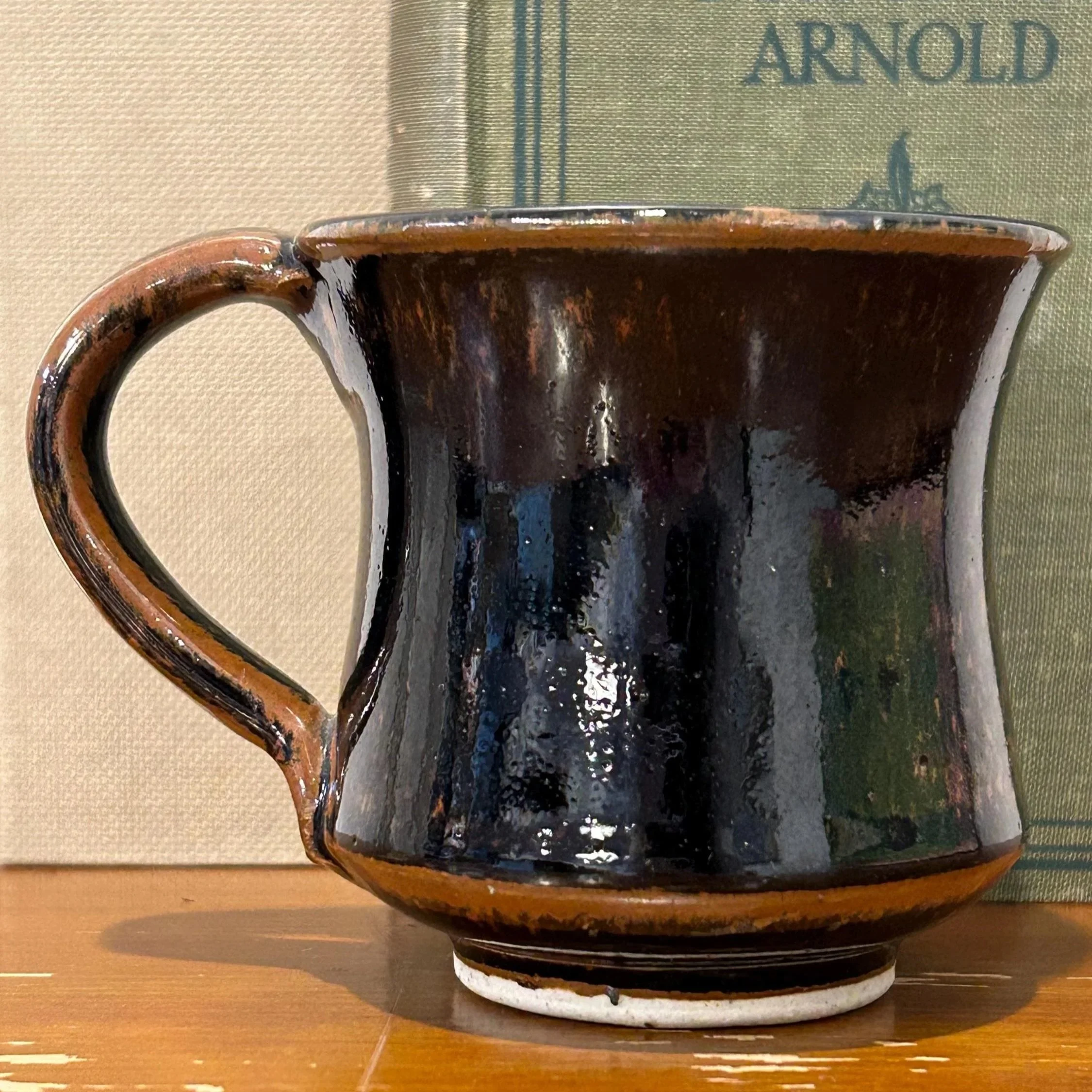 Close-up side profile of one mug showing flared rim and brown accents