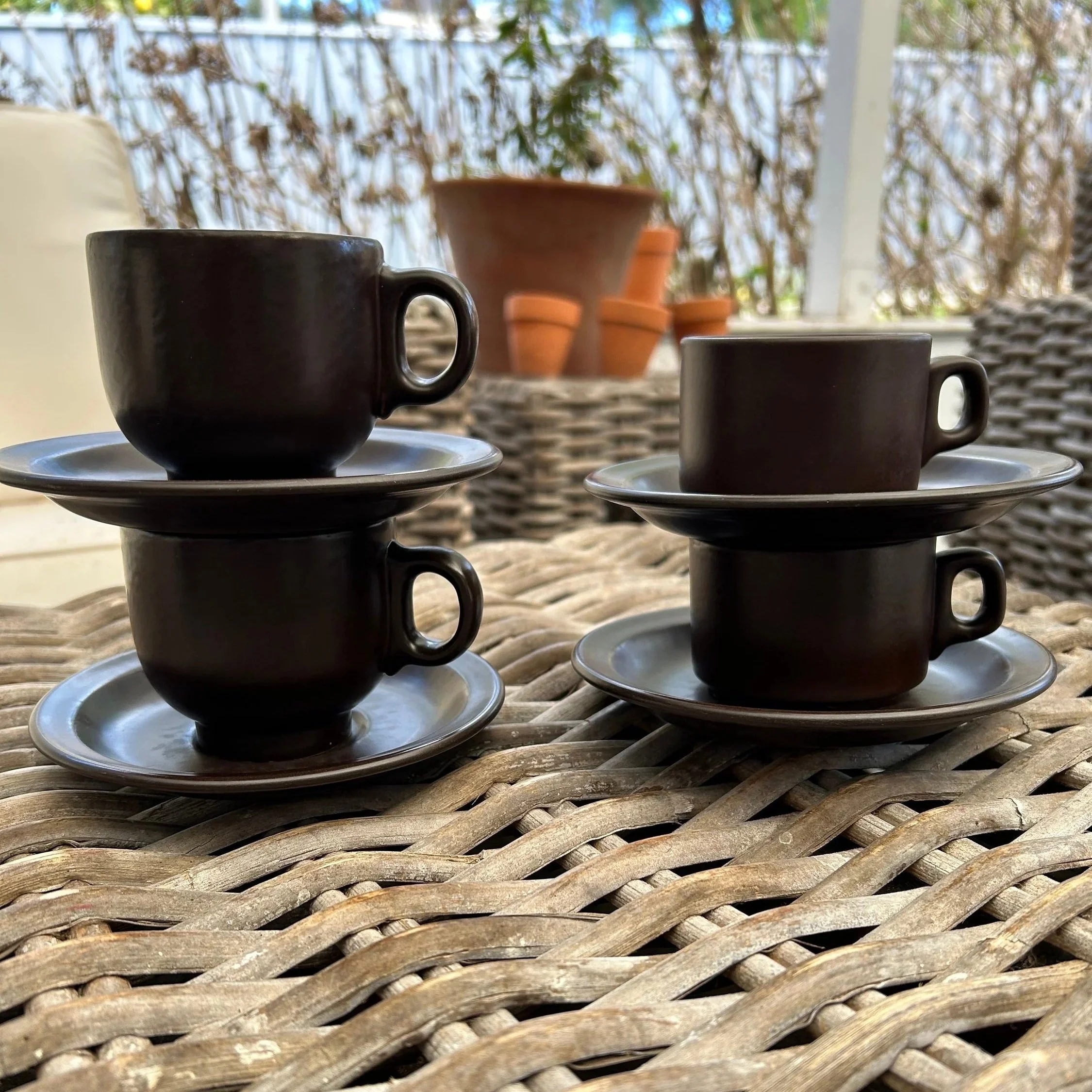 Stacked teacups and saucers showing form and finish