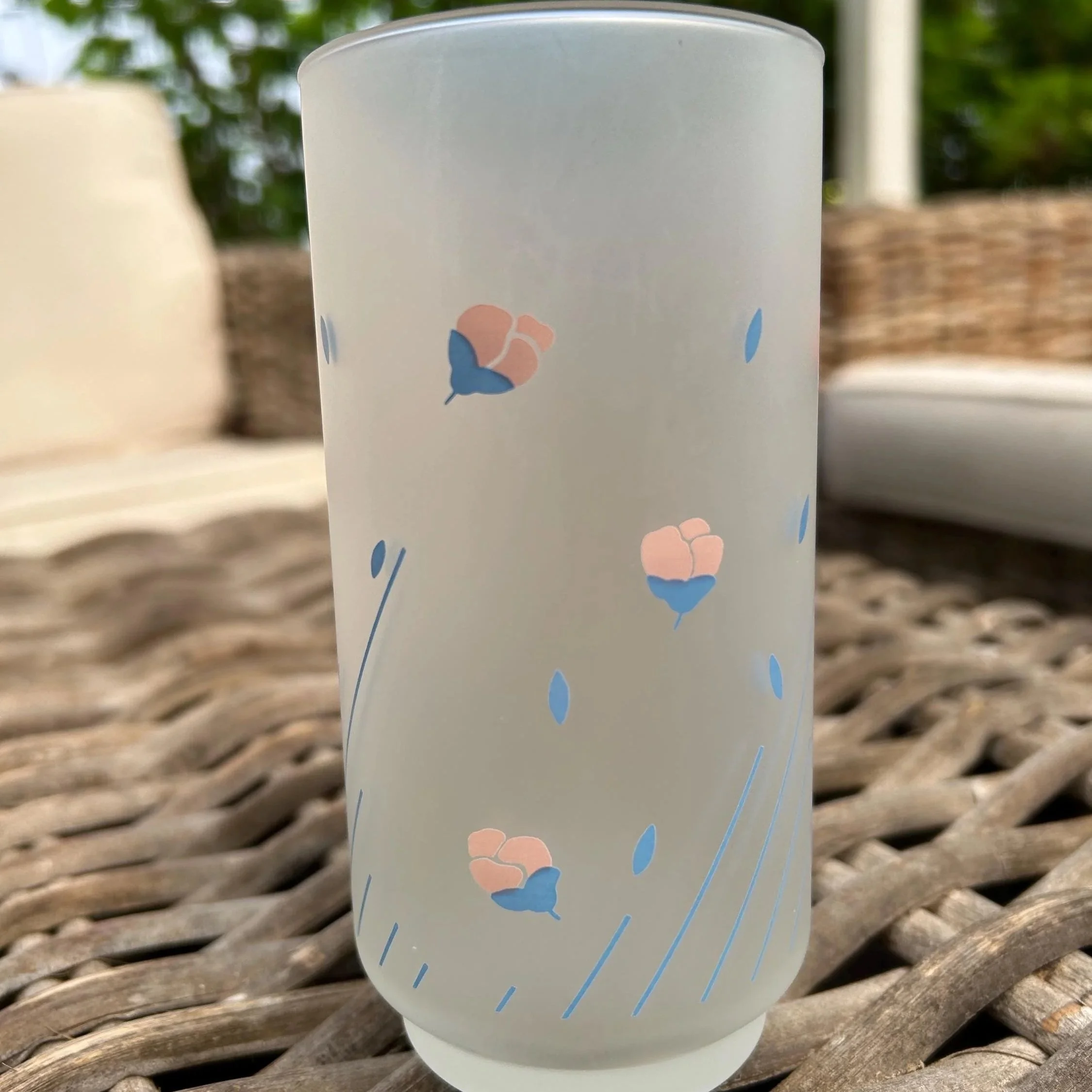 Close-up of pink and blue floral pattern with pinstripes on frosted glass