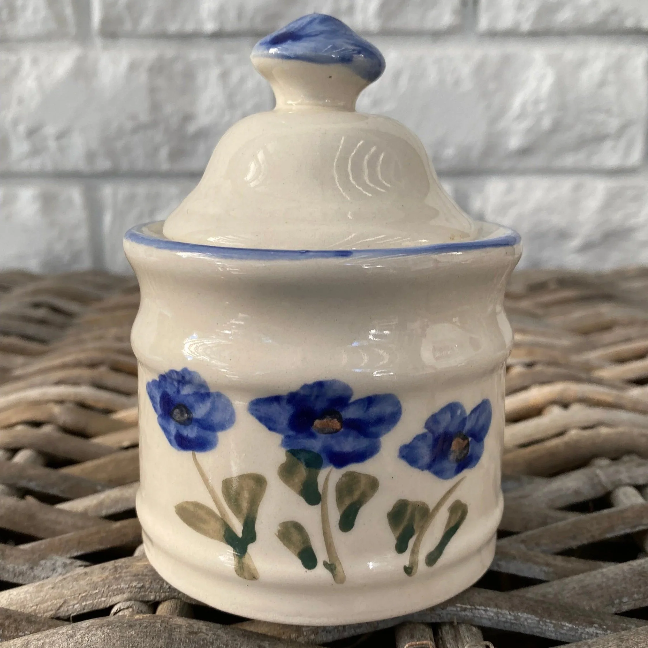 Close-up of sugar bowl with lid and vibrant blue flower motif
