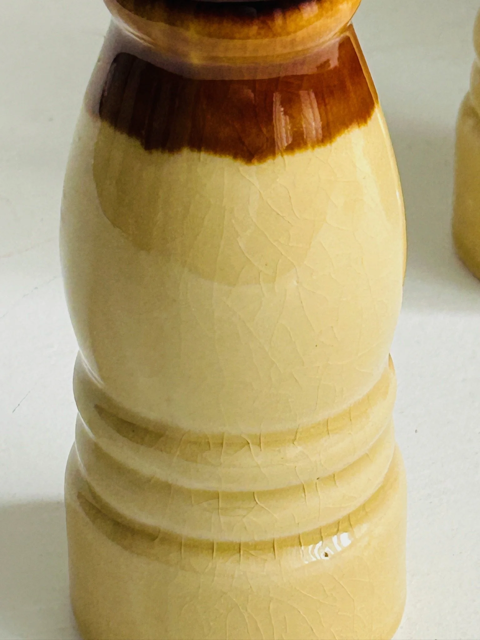 Close-up of the plain cream glazed body with visible vintage crazing