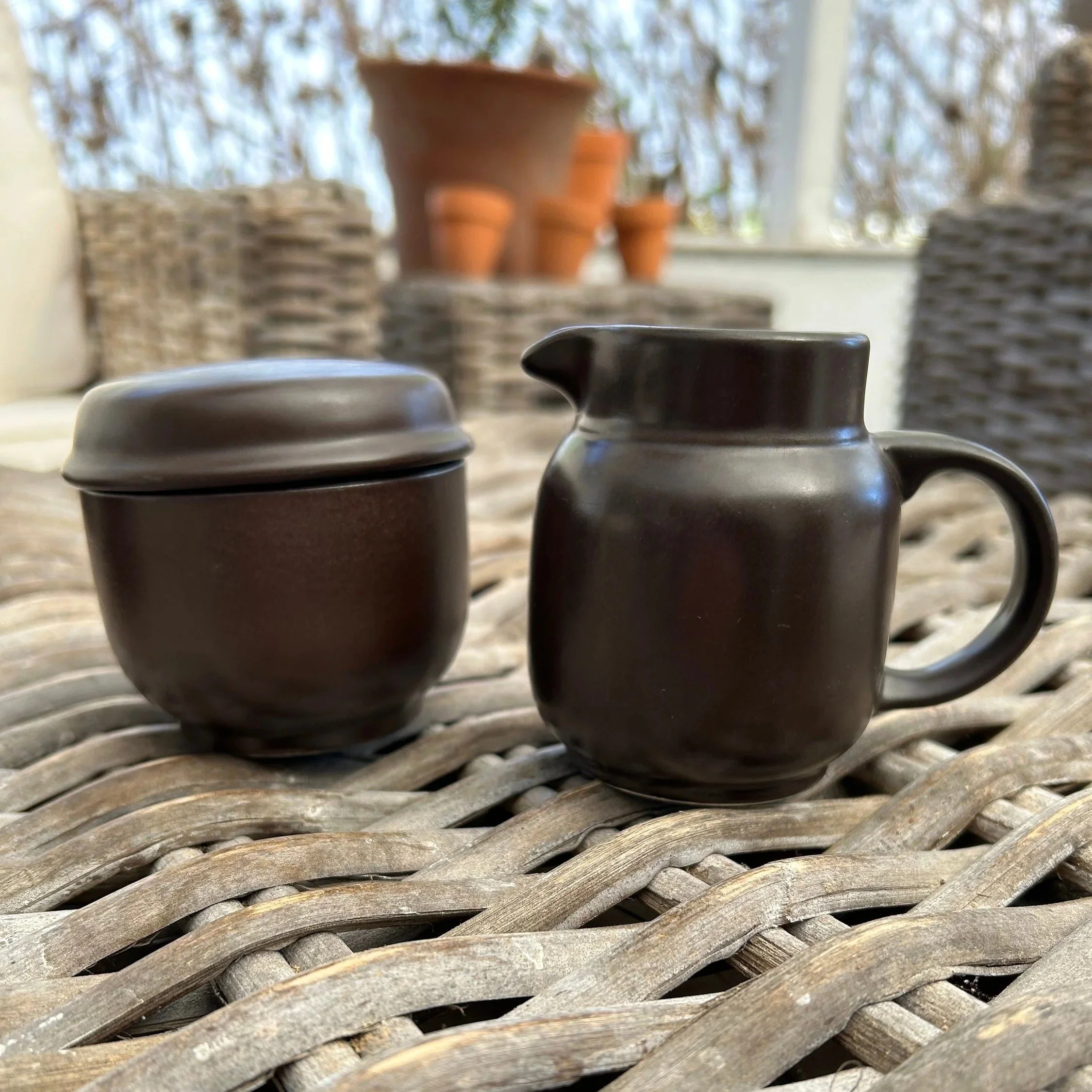 Sugar bowl and creamer with lids placed side by side