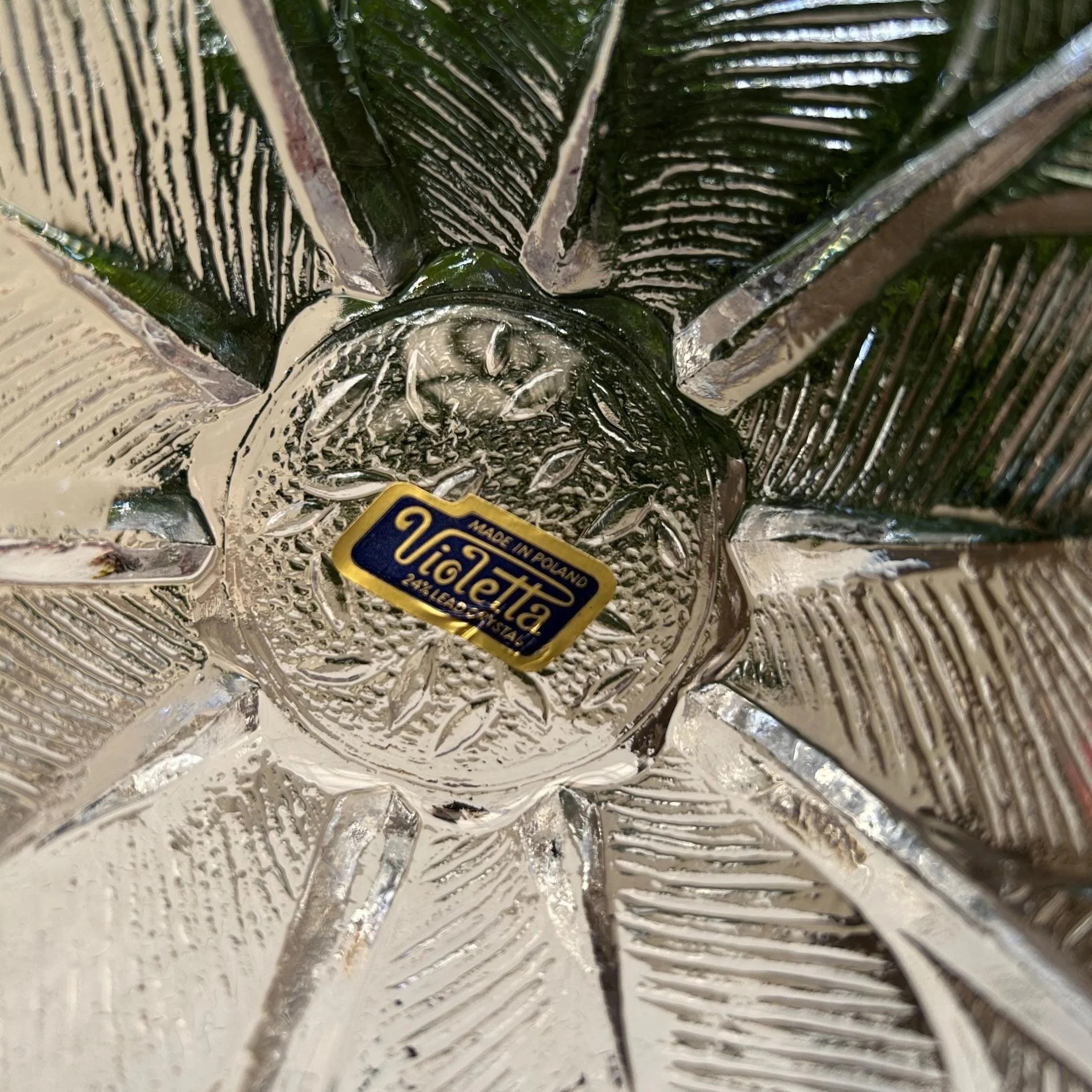 Underside of a bowl showing the original Violetta label and detailed pressed crystal base