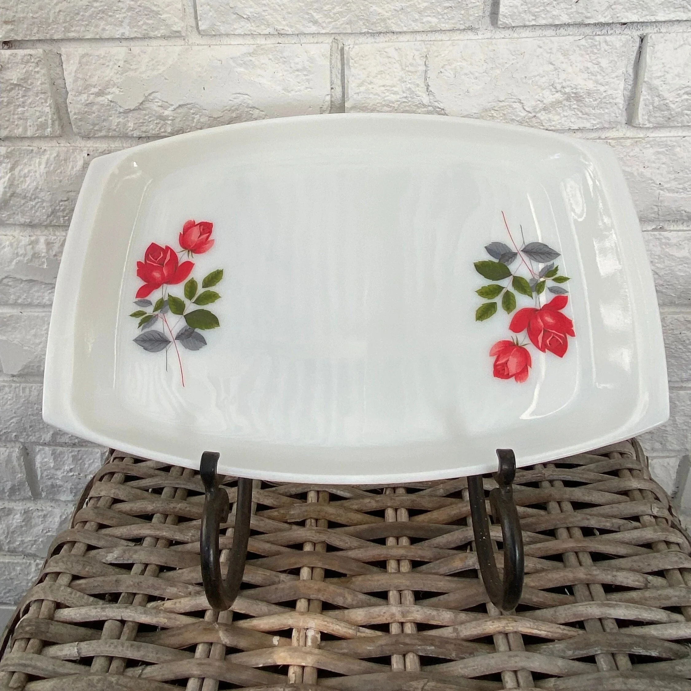 Front view of vintage JAJ Pyrex June Rose serving tray on stand, rose motifs visible