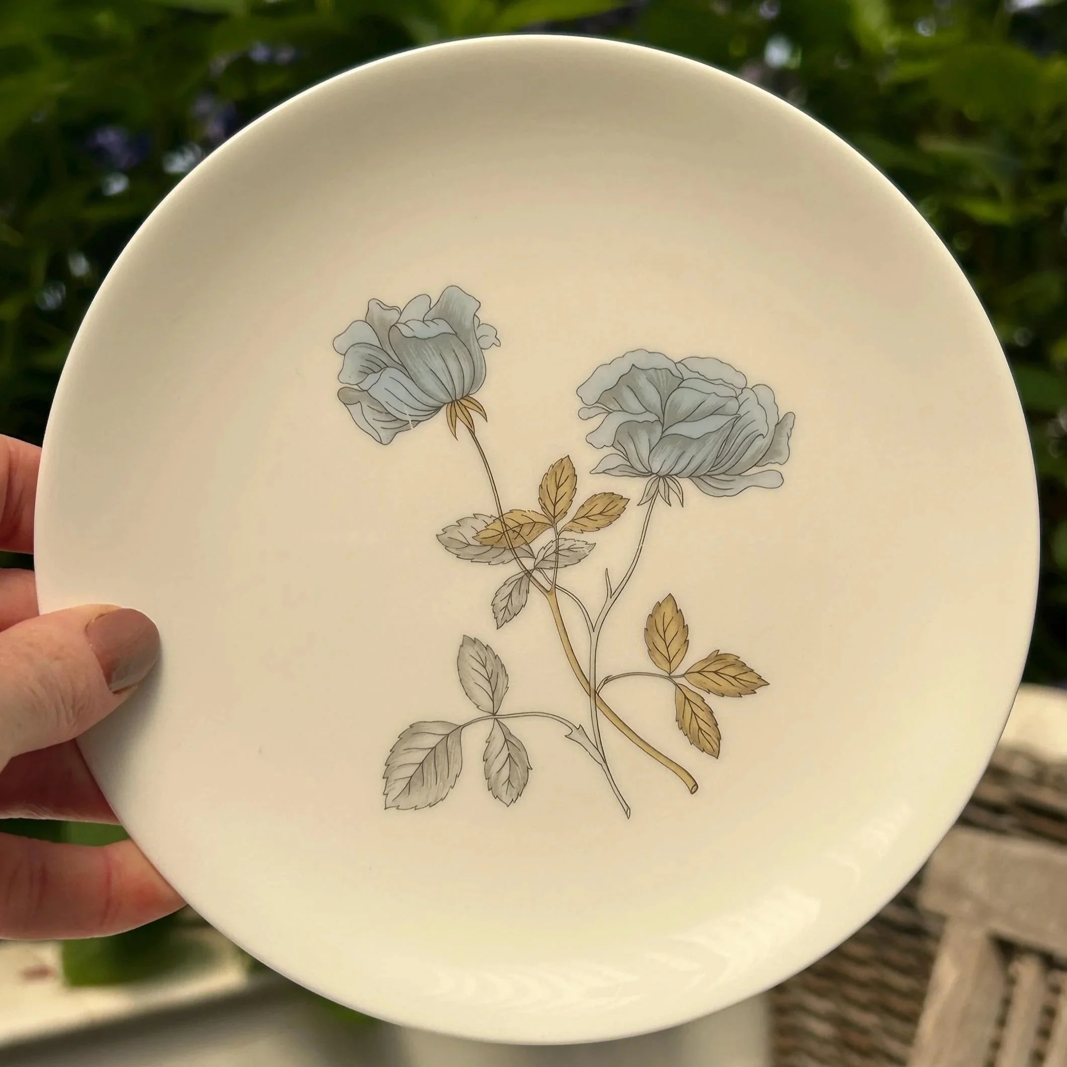 Saucer viewed from above, showing the larger blue rose spray and clean white bone china