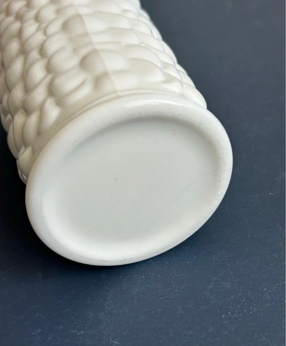 Unmarked base of white milk glass grape vase showing low moulded foot ring